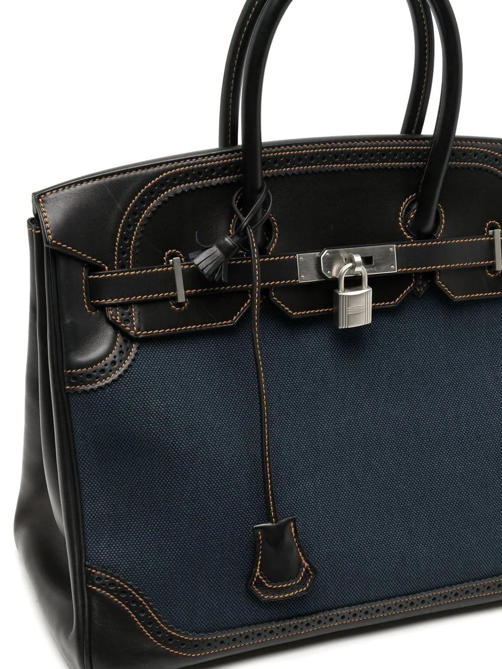 The Ghillies bags referred specifically to a Scottish version of the shoe, known as the ‘ghillie brogue’. 
A highly sought-after and sophisticated piece this Hermès Indigo Denim and Navy Blue Evercalf Leather Ghillies Birkin 35 is a truly special