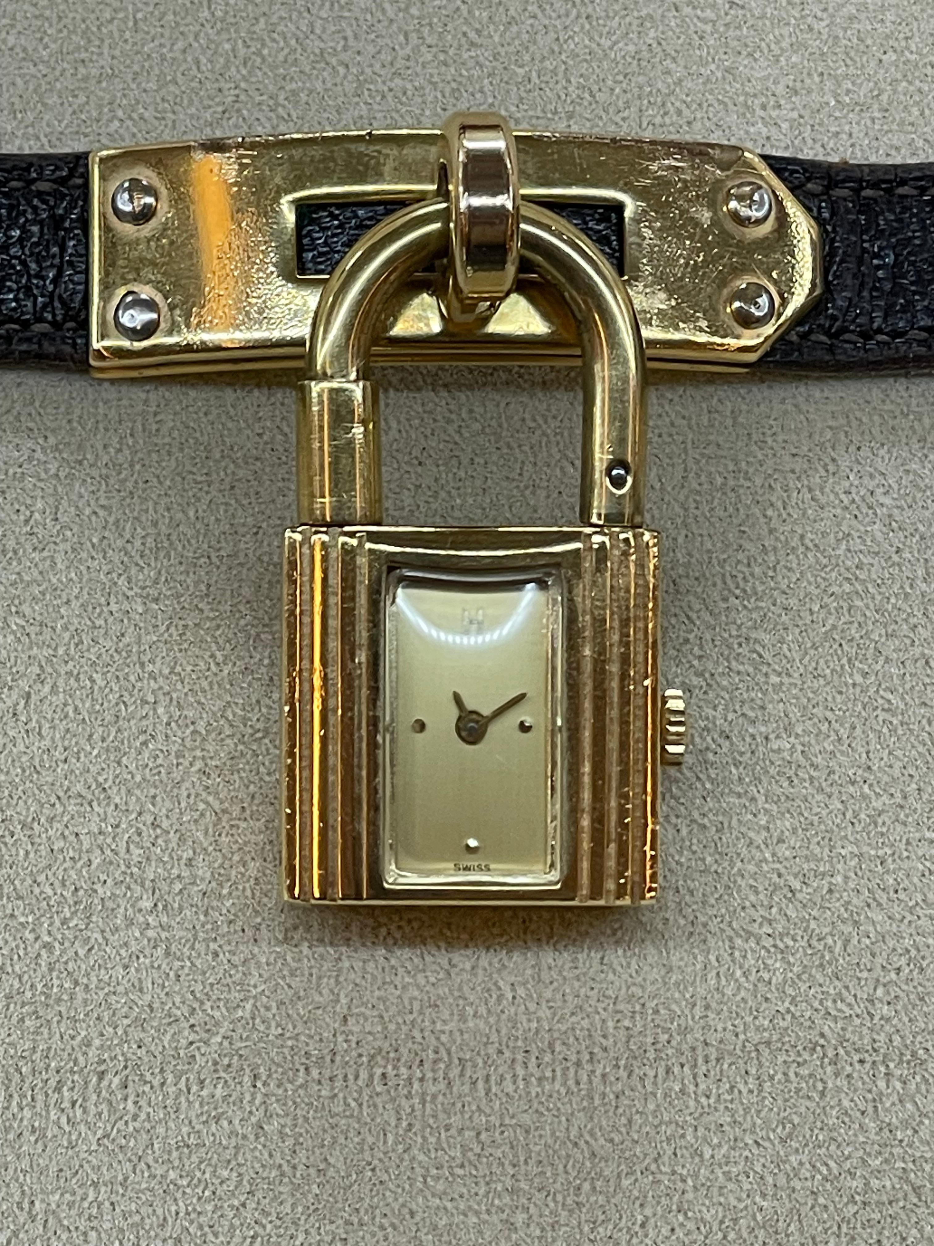 Hermès Gilt-Metal 'Kelly' Charm Bracelet-Watch

Quartz, padlock charm with rectangular numberless gold-tone dial, signed Hermès, no. 14432.

Watch measure 21.4mm Wide 37.87 High 8.67 Deep Band 6