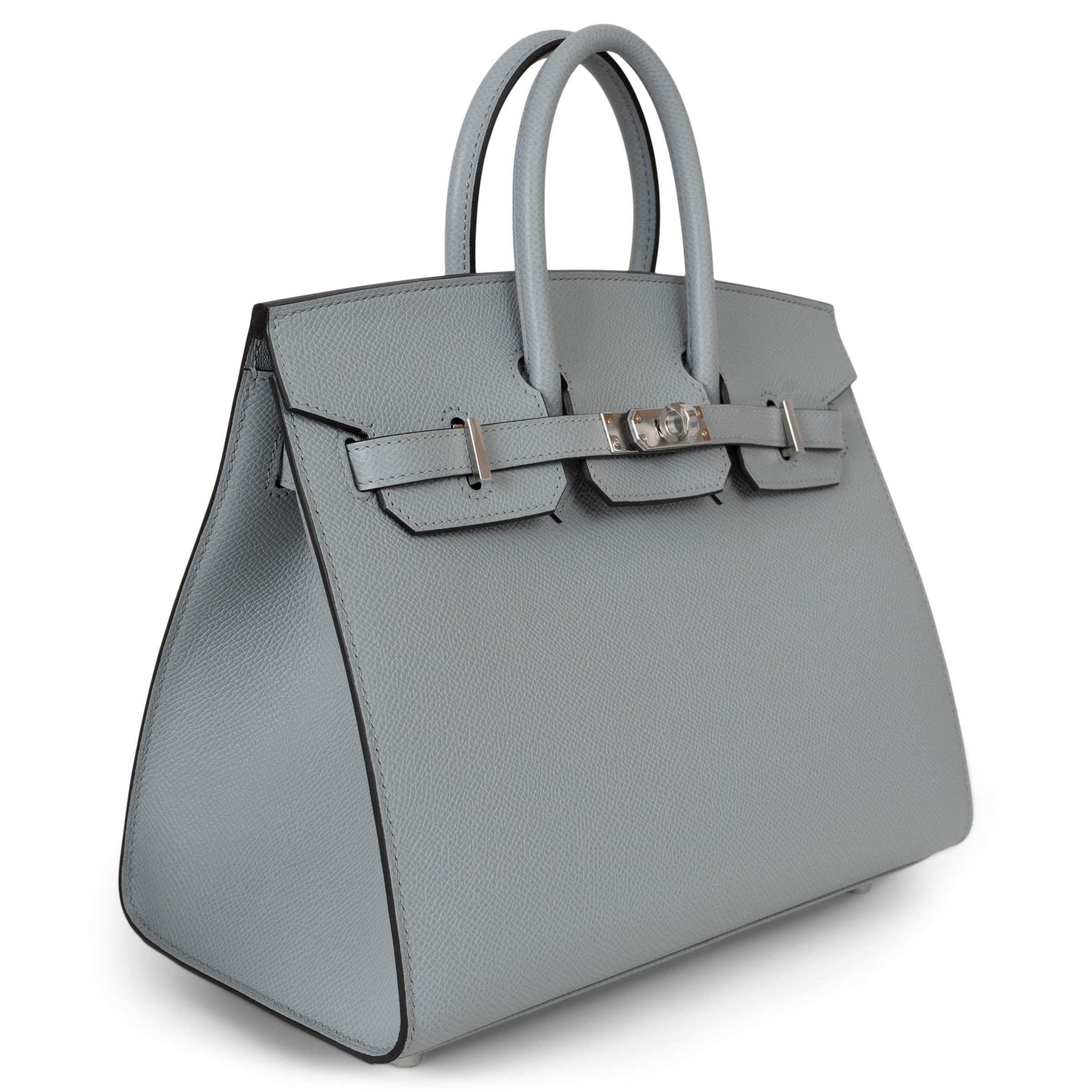 This 100% authentic Hermès Birkin 25 Sellier bag in Bleu Glacier (pale blue-grey) Veau Epsom leather is a true standout piece, featuring a size and color combination that is brand new to the market. Enhanced by palladium-plated hardware, its