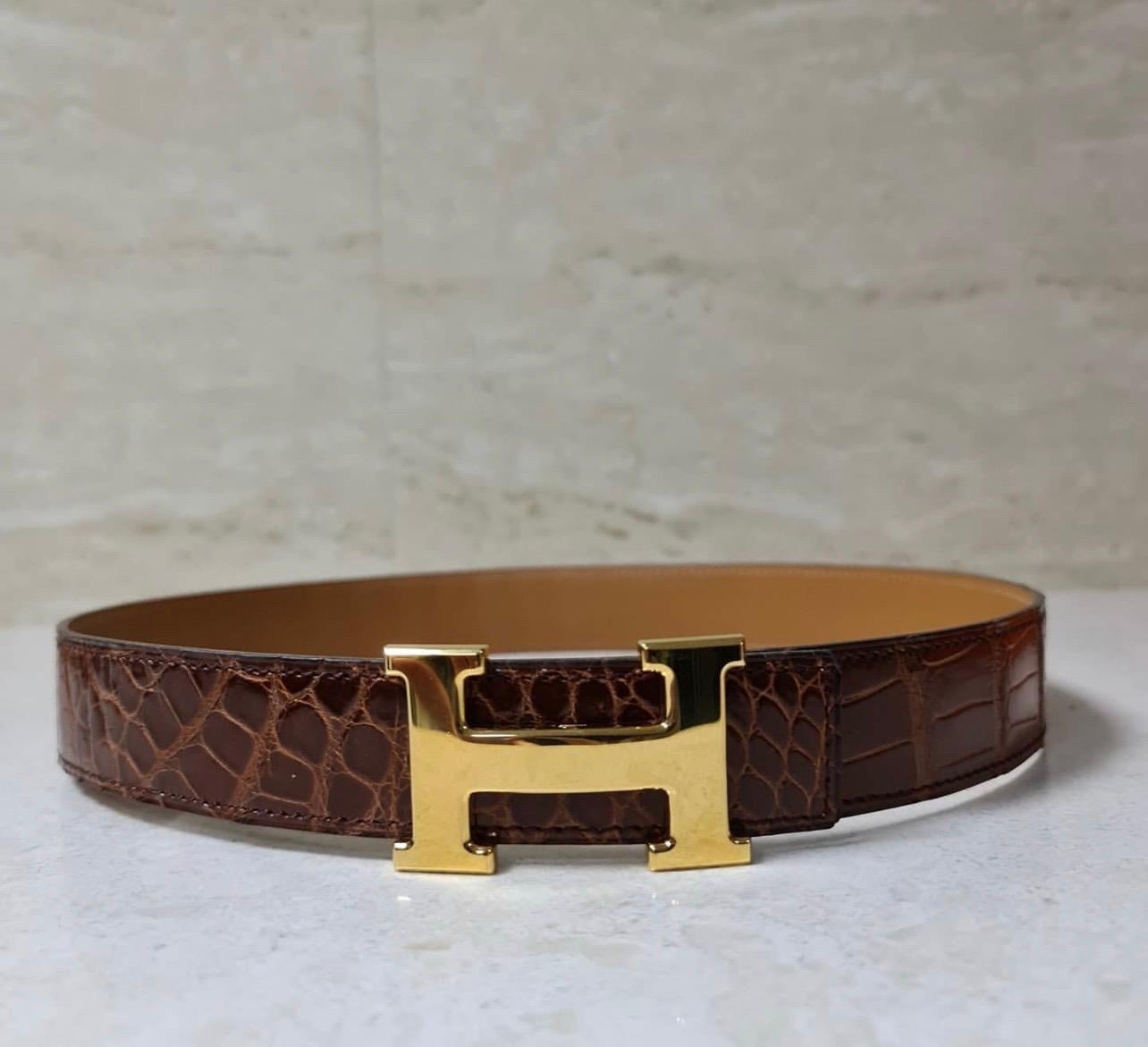 Superb Hermès belt H for women in crocodile glazed brown leather, H buckle in gold palladium metal. 
Smooth leather inside.
Width 3 cm; Buckle: 6 cm x 3.5 cm
Comes in original Hermes box.
Condition is very good but has some scraches on buckle.

For