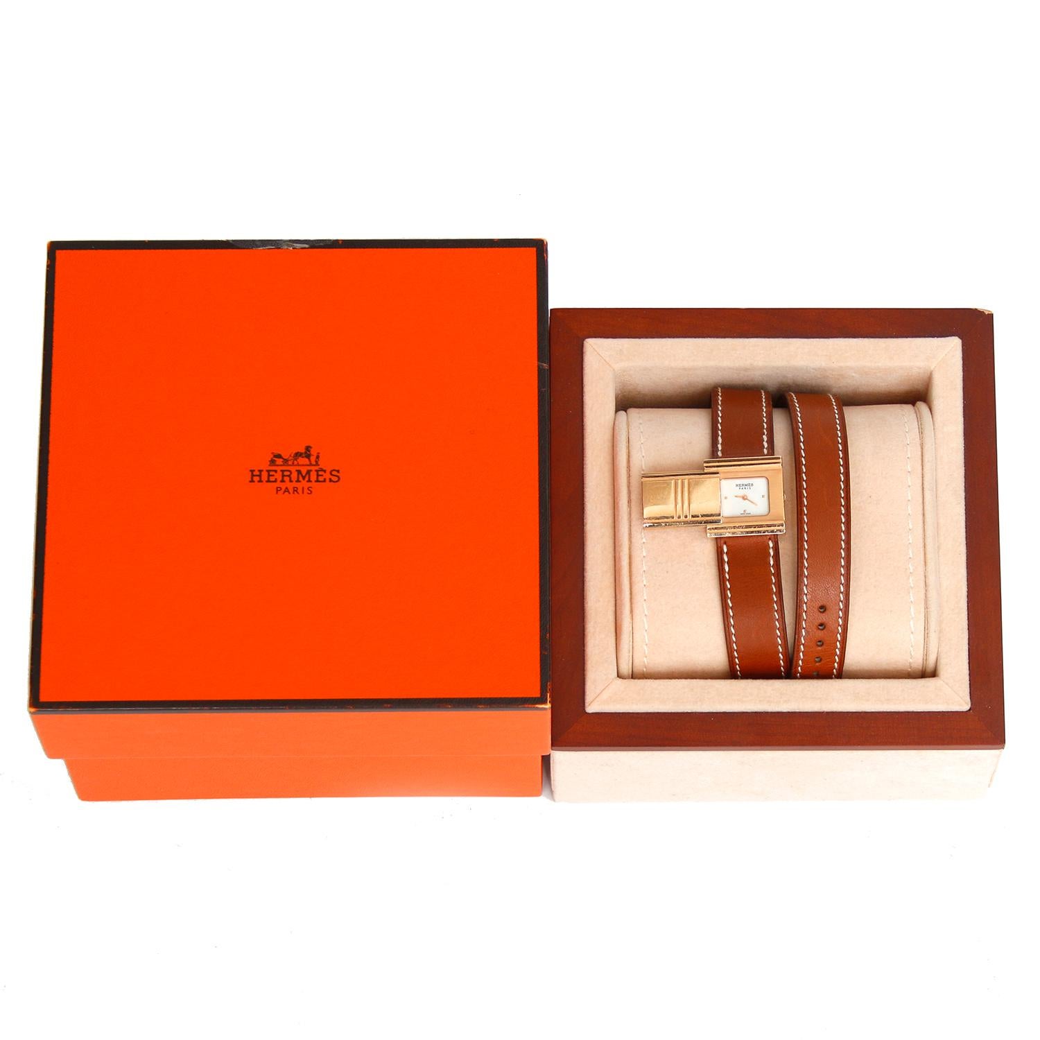 Hermes Glissade 18K Rose Gold Ladies Watch  - Quartz. 18K Rose Gold case ( 20 mm ) . Mother of Pearl . Brown leather strap with tang buckle . Pre-owned with Hermes box .