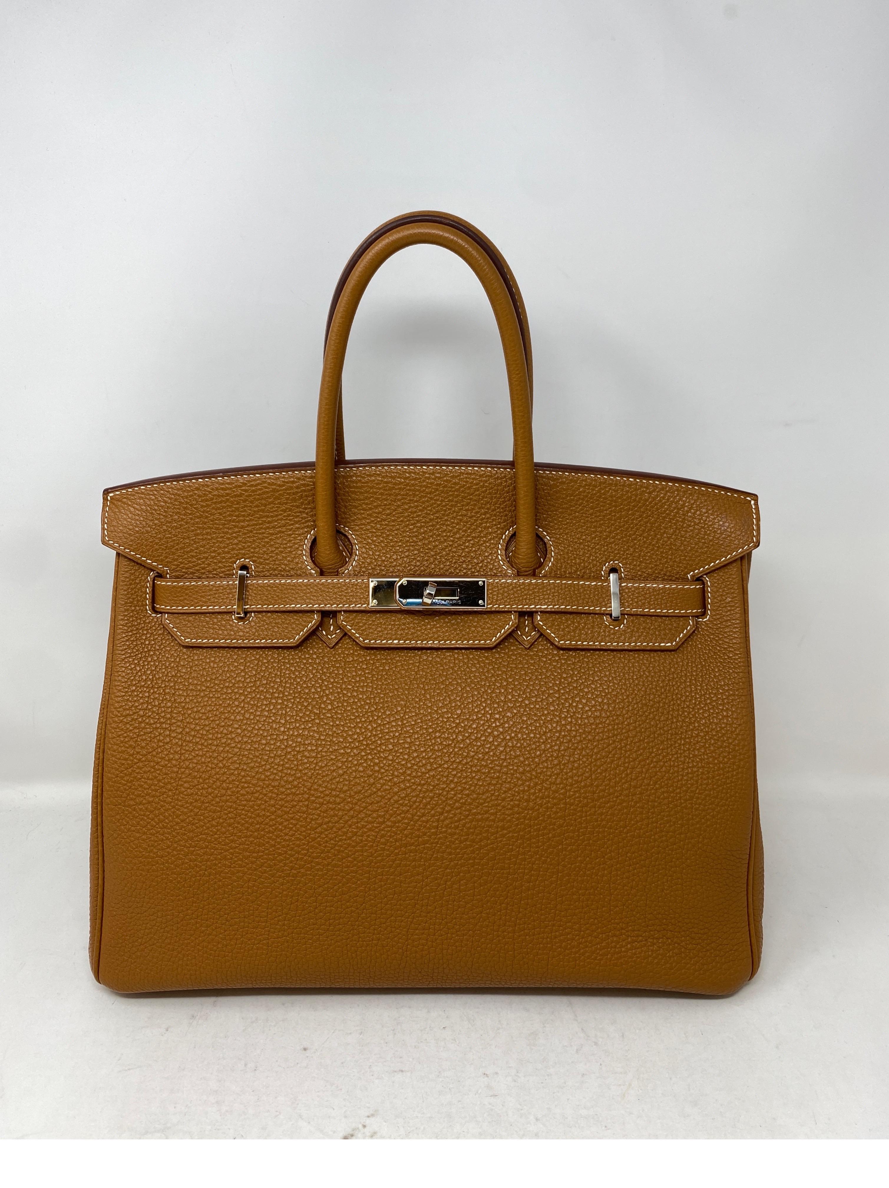Hermes Gold Birkin 35 Bag. Gold tan leather color with palladium hardware. The most classic Birkin Bag. Togo leather. Excellent condition like new. Includes clochette, lock, keys and dust cover. Guaranteed authentic. Don't miss out on this one. 