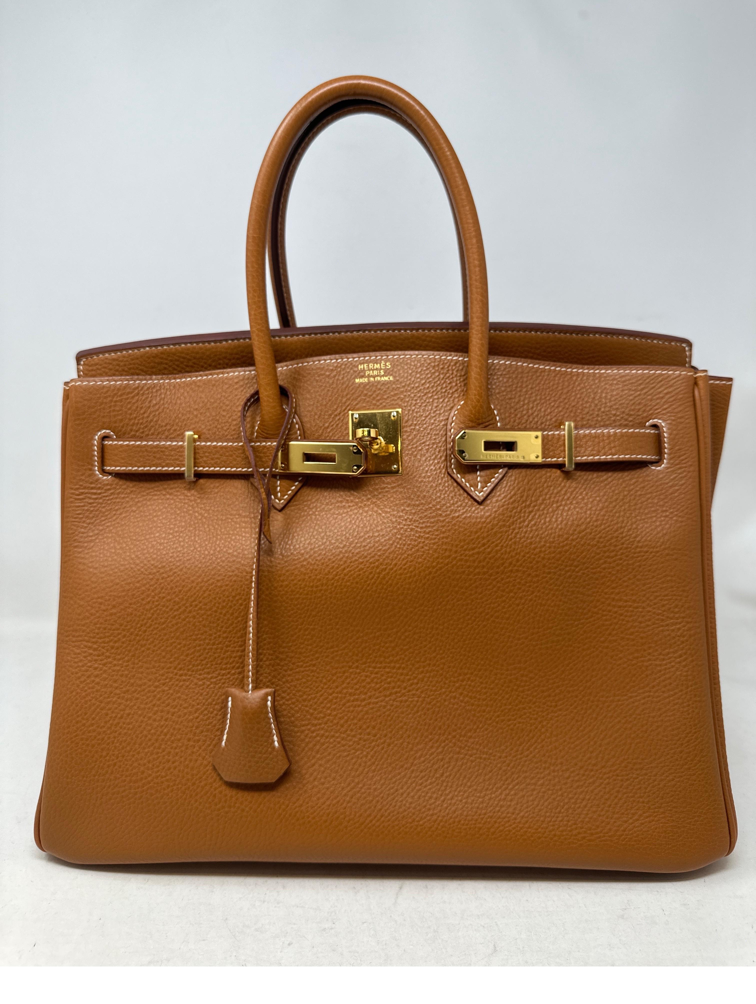 Hermes Gold Birkin 35 Bag. Excellent condition. Most coveted combination. Gold with gold hardware. Interior clean. Togo leather with plastic still on the hardware. This bag is amazing. Great investment bag. Priced to sell. Includes clochette, lock,