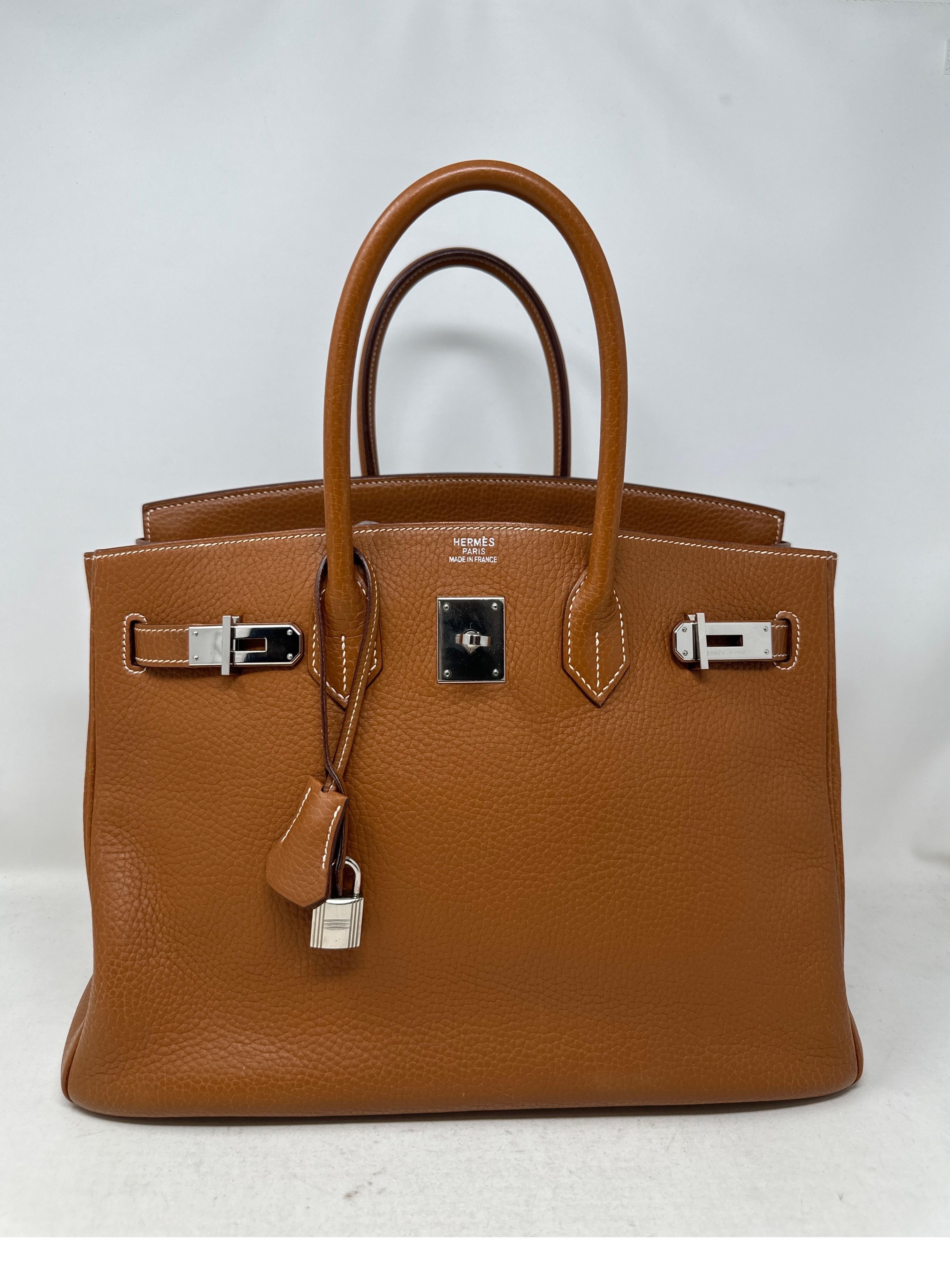 Hermes Gold Birkin 35 Bag. Clemence leather. Palladium silver hardware. Most wanted classic Hermes color gold. Tan brown color. Interior clean. Includes clochette, lock, keys, and dust bag. Guaranteed authentic. Don't miss out on this classic