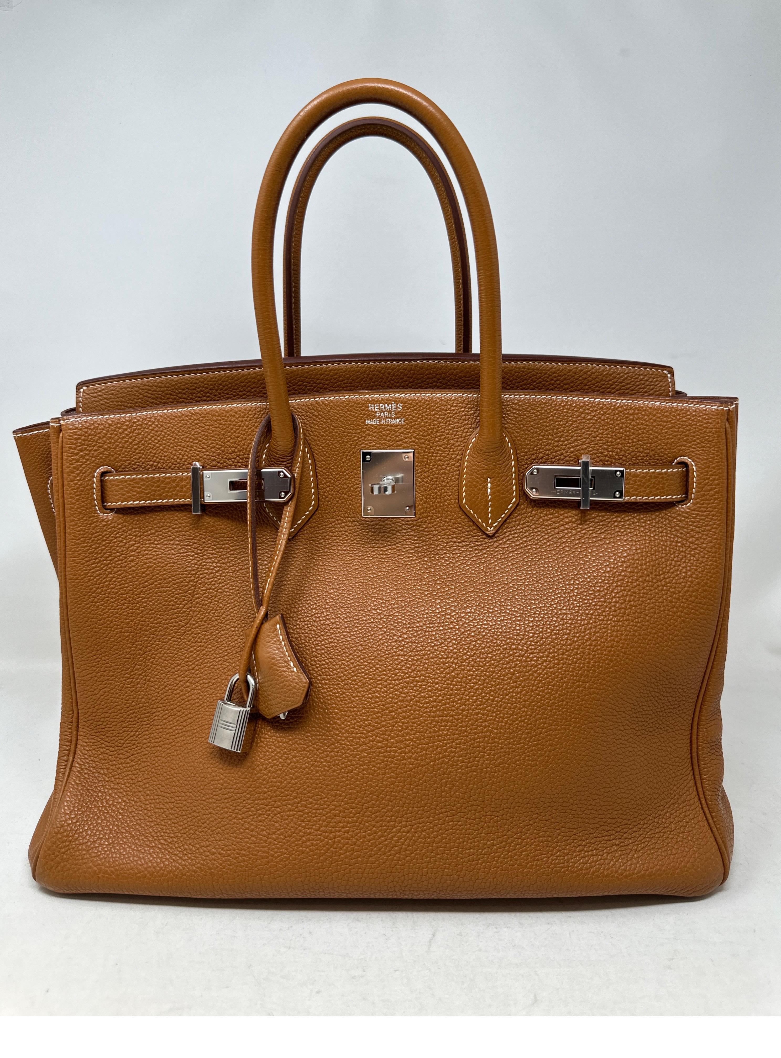 Hermes Gold Birkin 35 with Palladium Hardware. Togo leather. Full restoration cleaning at Hermes with the receipt for the work. The bag looks like new condition. Plastic is still on the hardware. Interior is clean. The most wanted color gold tan.