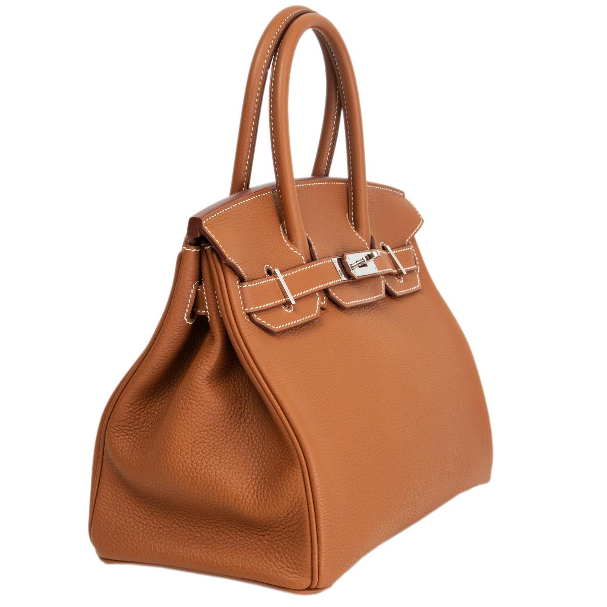 100% authentic Hermès Birkin 30 bag in Gold (camel brown) Veau Togo leather with contrasting white stitching and Palladium hardware. Lined in Chevre (goat skin) with an open pocket against the front and a zipper pocket against the back. Has never