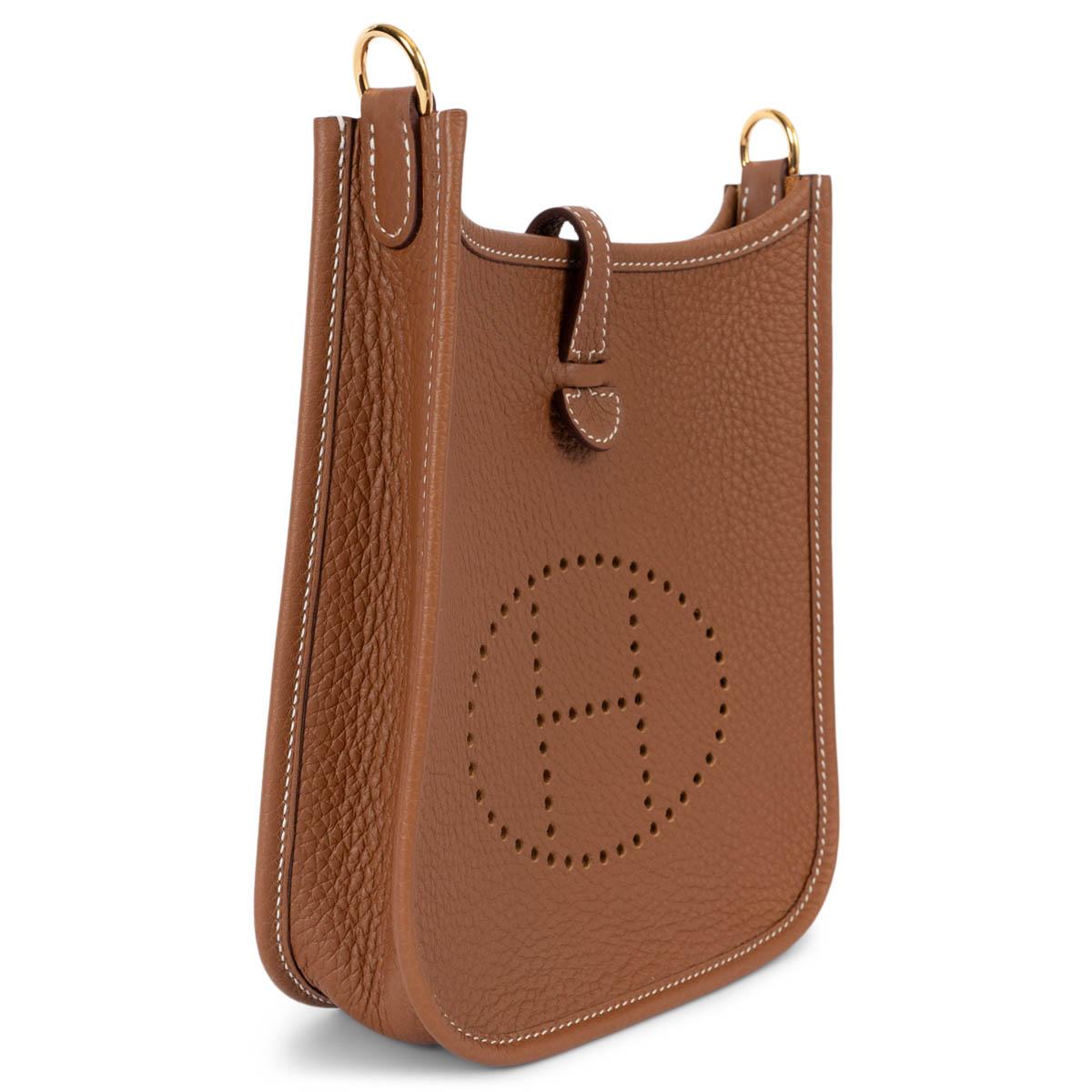 100% authentic Hermès Evelyne 16 TPM Crossbody Bag in Gold (camel) Taurillon Clemence leather with a gold wool sangle strap, perforated leather 