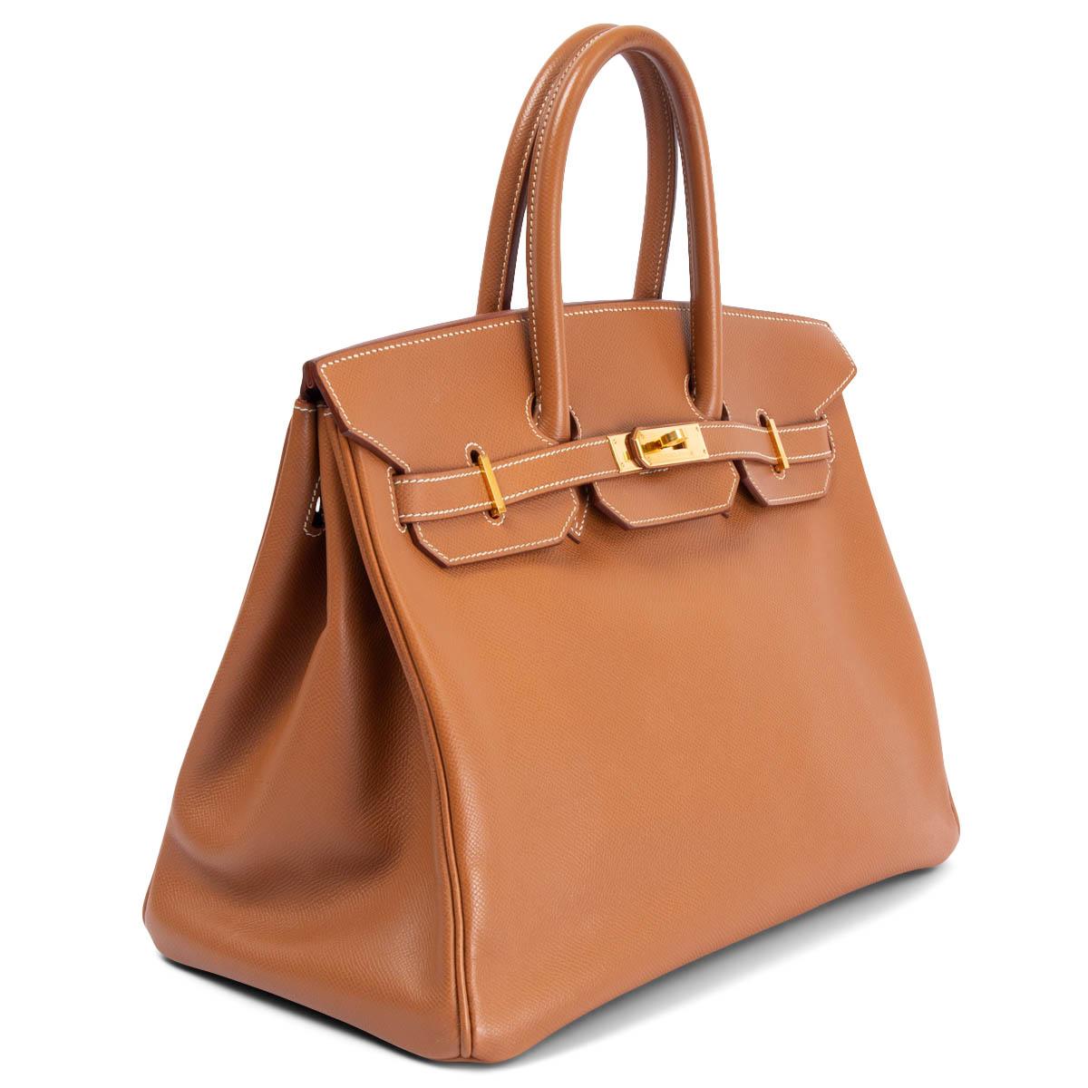 100% authentic Hermès Birkin 35 bag in Gold (camel brown) Veau Epsom leather. Lined in Chevre (goat skin) with an open pocket against the front and a zipper pocket against the back. Has been carried with soft wear to the corners, a tiny dark spot on