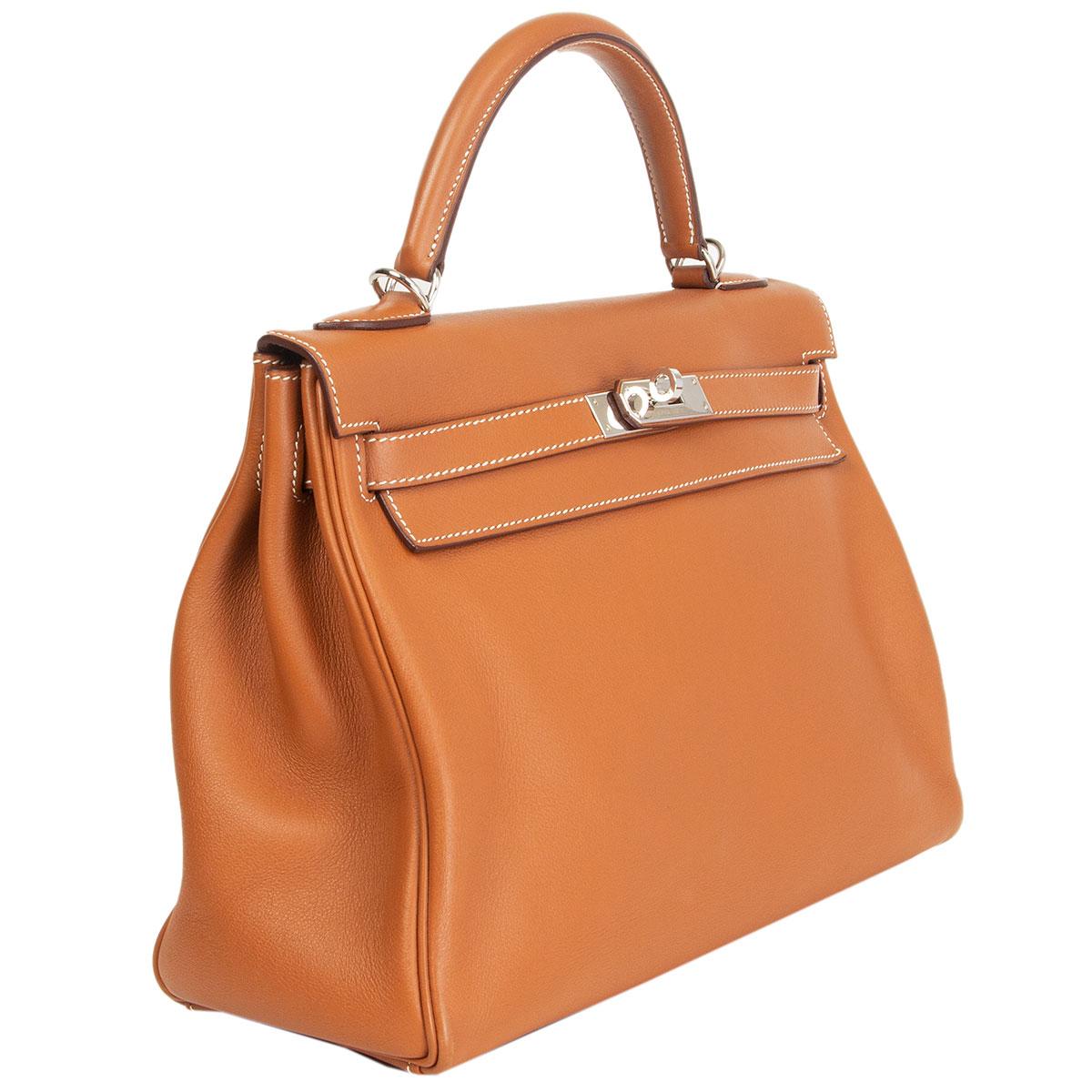 Hermes 'Kelly II 32 Retourne' bag in Gold (camel) Veau Swift leather with palladium-plated hardware. The interior is lined in Chevre (goat skin) with a divided open pocket against the front and a zipper pocket against the back. Has been carried and