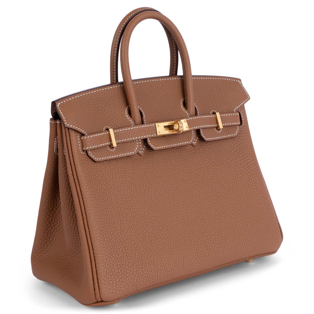 100% authentic Hermès Birkin 25 bag in Gold (camel) Veau Togo leather with gold-plated hardware. Lined in Gold Chevre (goat skin) with an open pocket against the front and zipper pocket against the back. Brand new - comes with full