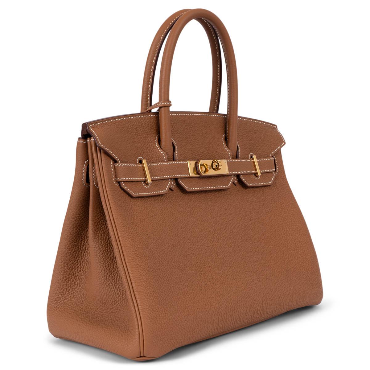 100% authentic Hermès Birkin 30 bag in Gold camel Veau Togo leather with gold-plated hardware. Lined in Chevre (goat skin) with an open pocket against the front and a zipper pocket against the back. Brand new - comes with full