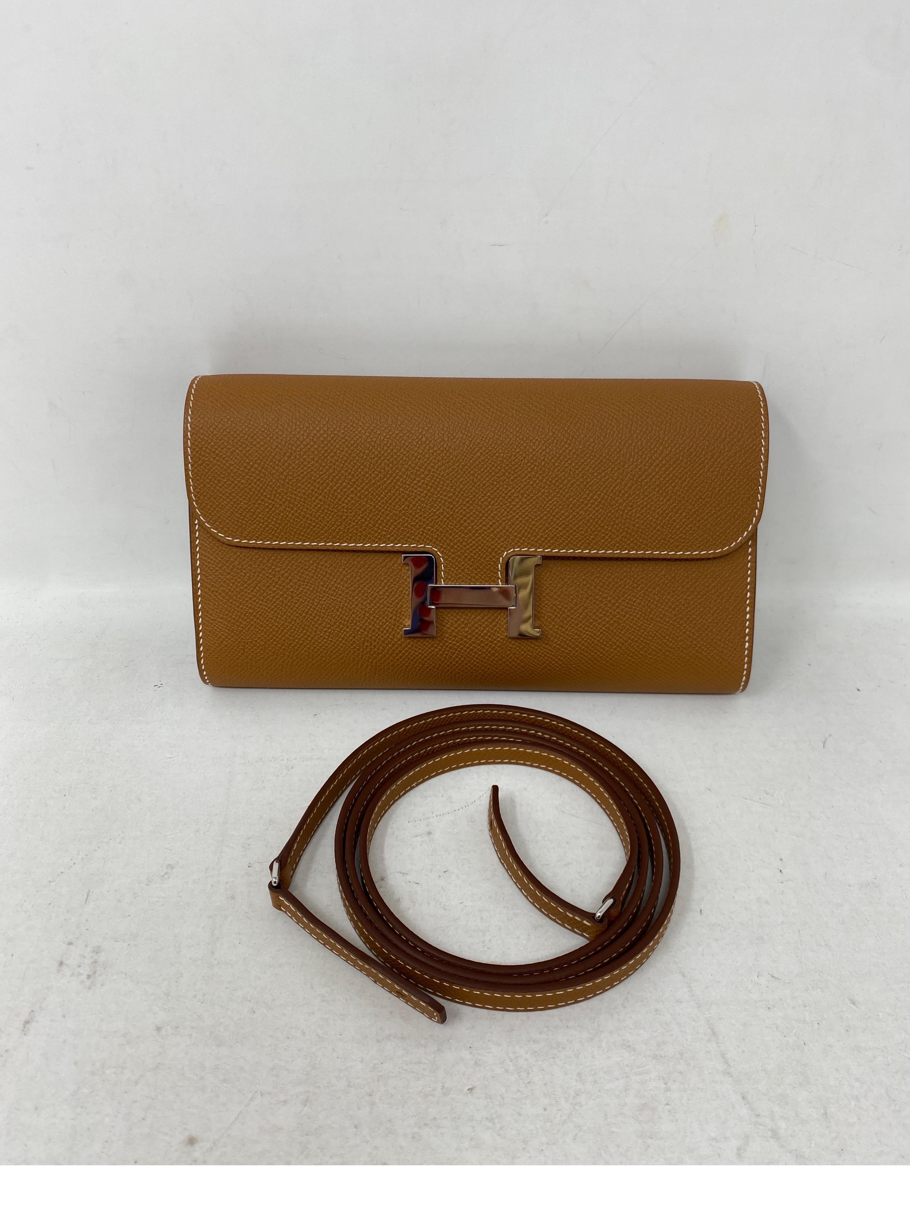 Hermes Gold Constance To Go Wallet Bag. Brand new and in box. Palladium silver hardware. Can be worn as a clutch or wallet. Also can be worn as a crossbody bag. Receipt included. Hard to get Hermes bag. Most wanted gold tan color by Hermes.