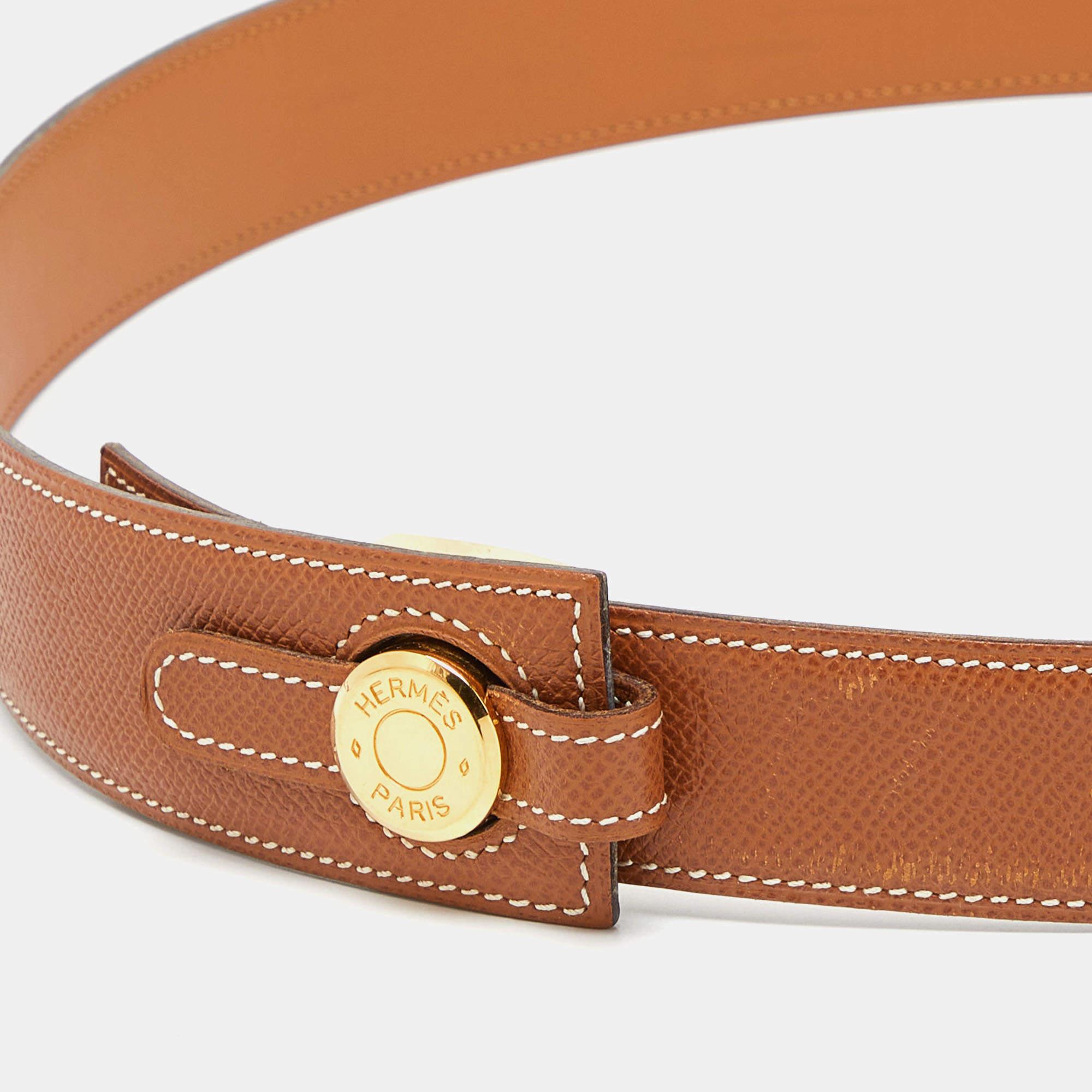 The Hermès Clou de Selle belt is a luxurious and eye-catching accessory. Crafted from Epsom leather, it features the buckle in gold-tone, showcasing elegance and sophistication in a versatile and stylish design.

