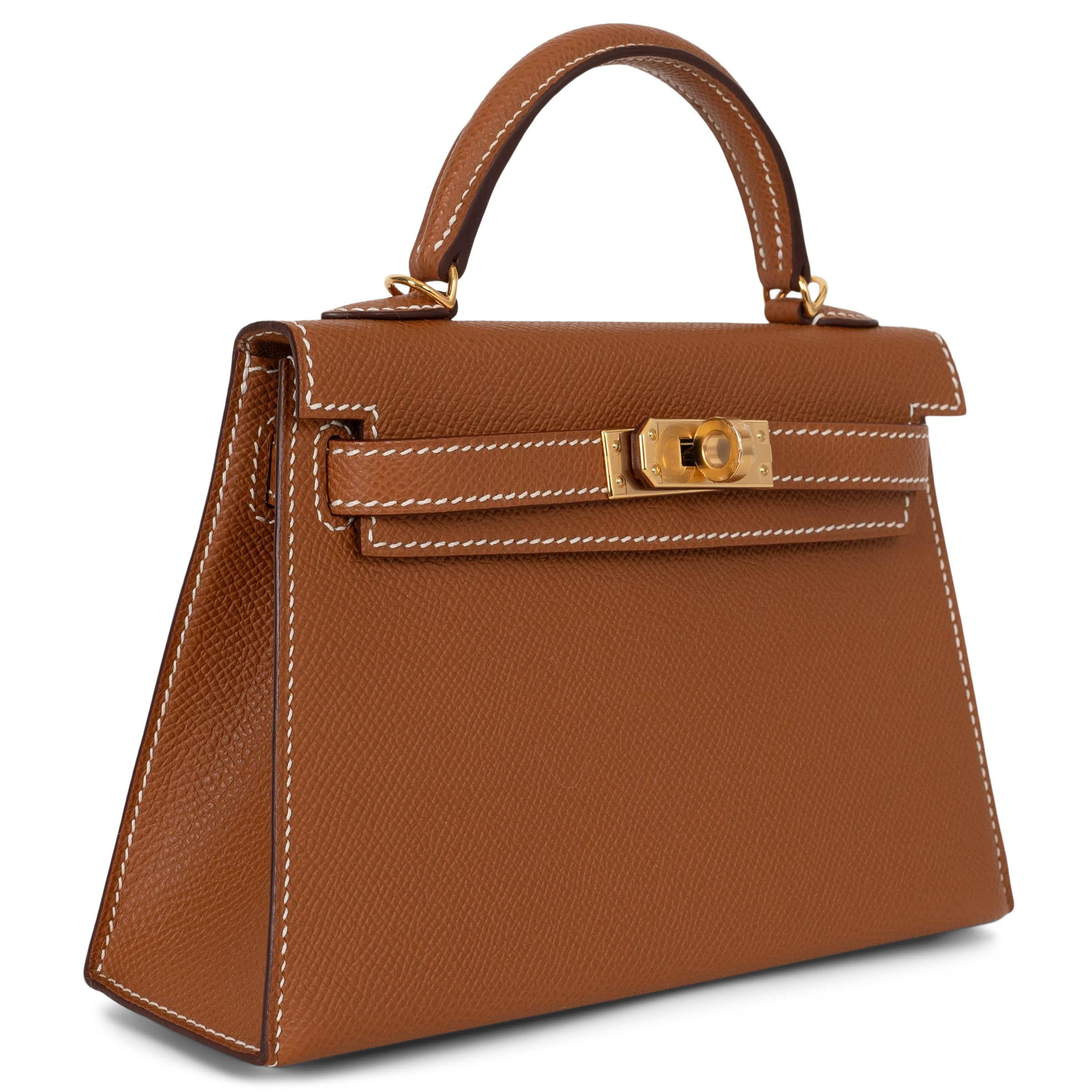 This 100% authentic Hermès Mini Kelly 20 Sellier bag in Gold (camel) Veau Epsom leather is a timeless icon in a compact size. Featuring gold-plated hardware and the brand’s signature structured silhouette, it exudes understated elegance. The