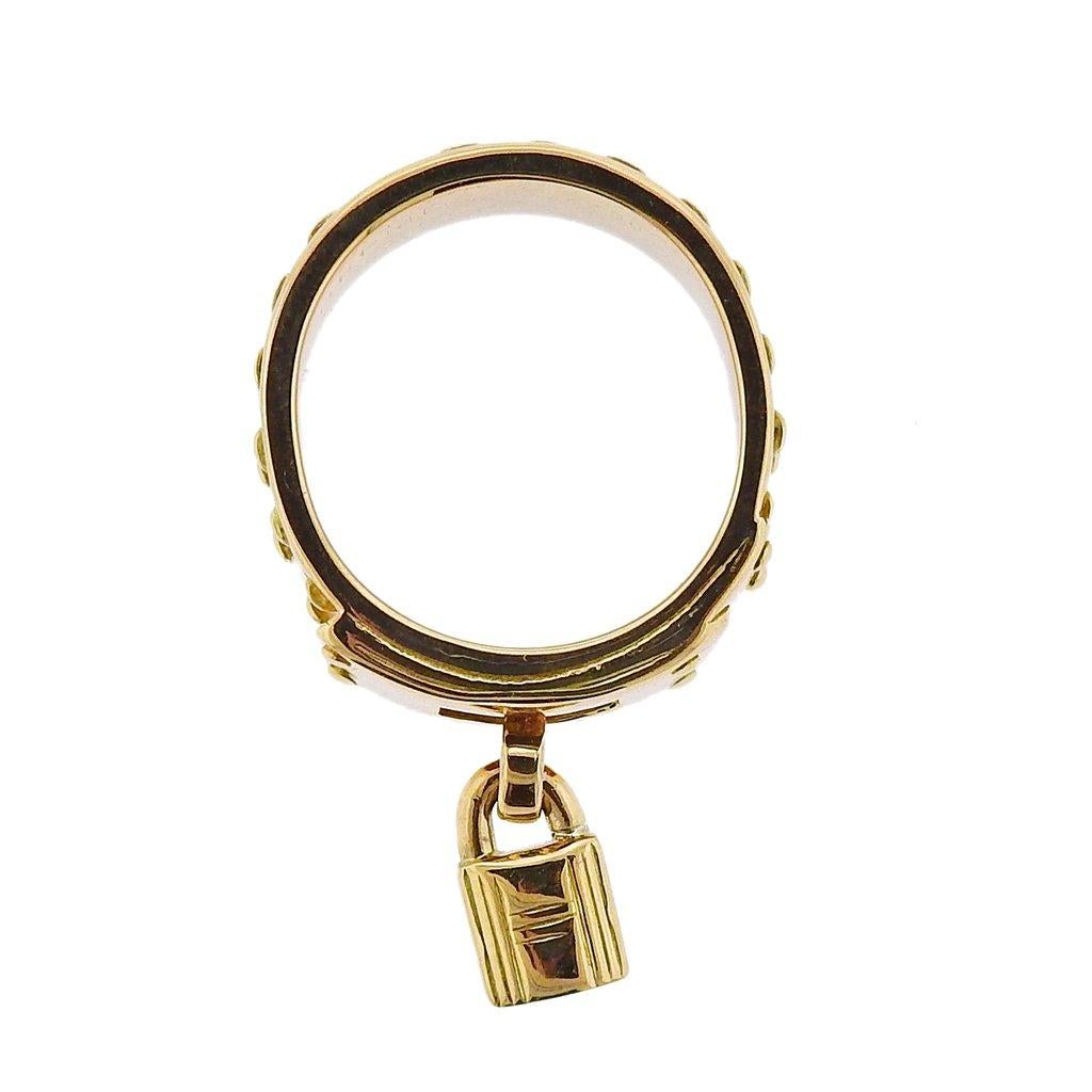 18k yellow gold Hermes ring, featuring signature Kelly lock charm. Ring size - 6, ring is 7.5mm wide, charm - 9mm x 5mm. Weight is 12.8 grams. Marked French marks on the outside of the shank, Hermes, 52, 750, 25623.