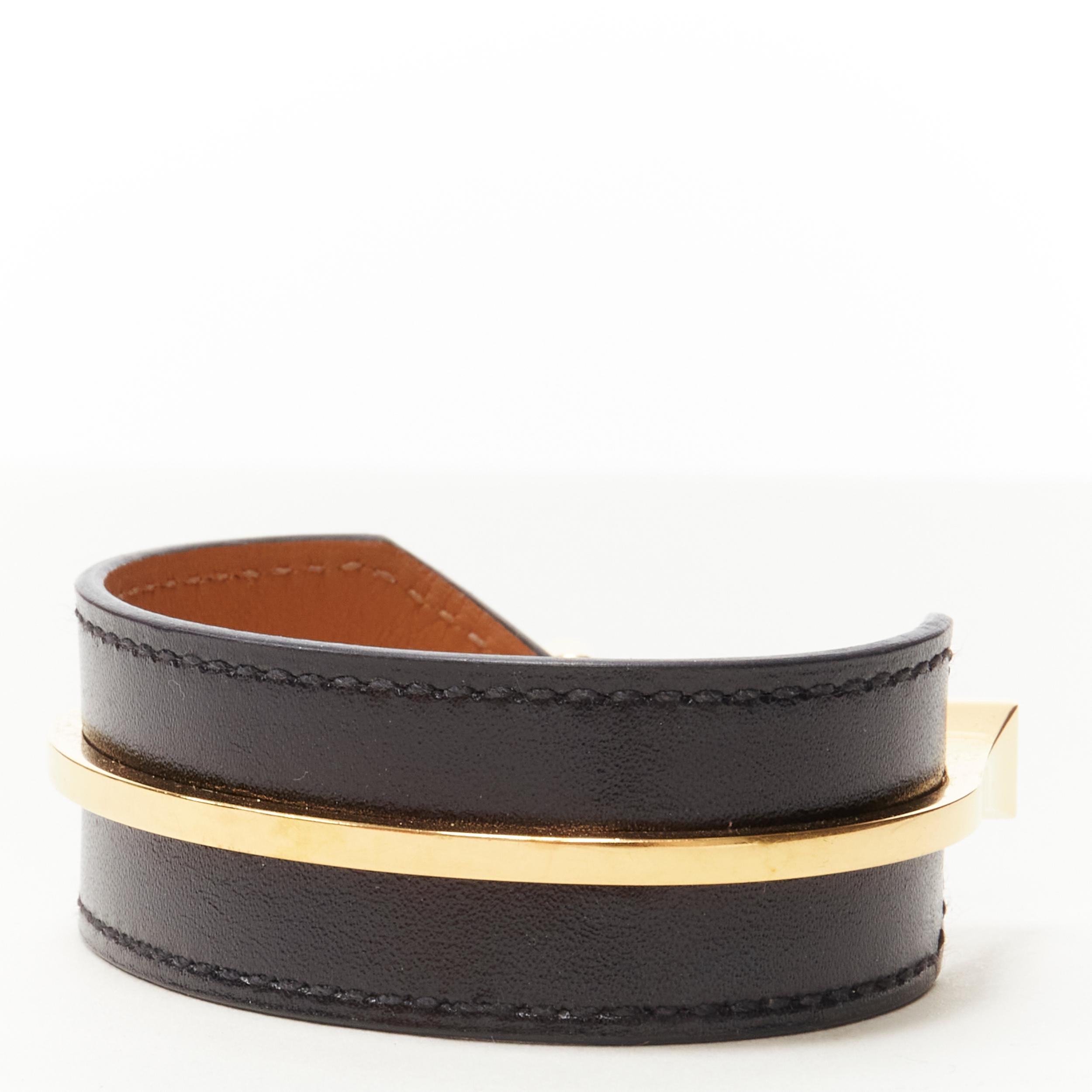 HERMES gold plated brass black leather open cuff minimal bracelet 
Reference: KEDG/A00010 
Brand: Hermes 
Material: Leather 
Color: Black 
Pattern: Solid 
Extra Detail: Minimal cuff. Wide black leather cuff with gold-plated brass cuff attached.