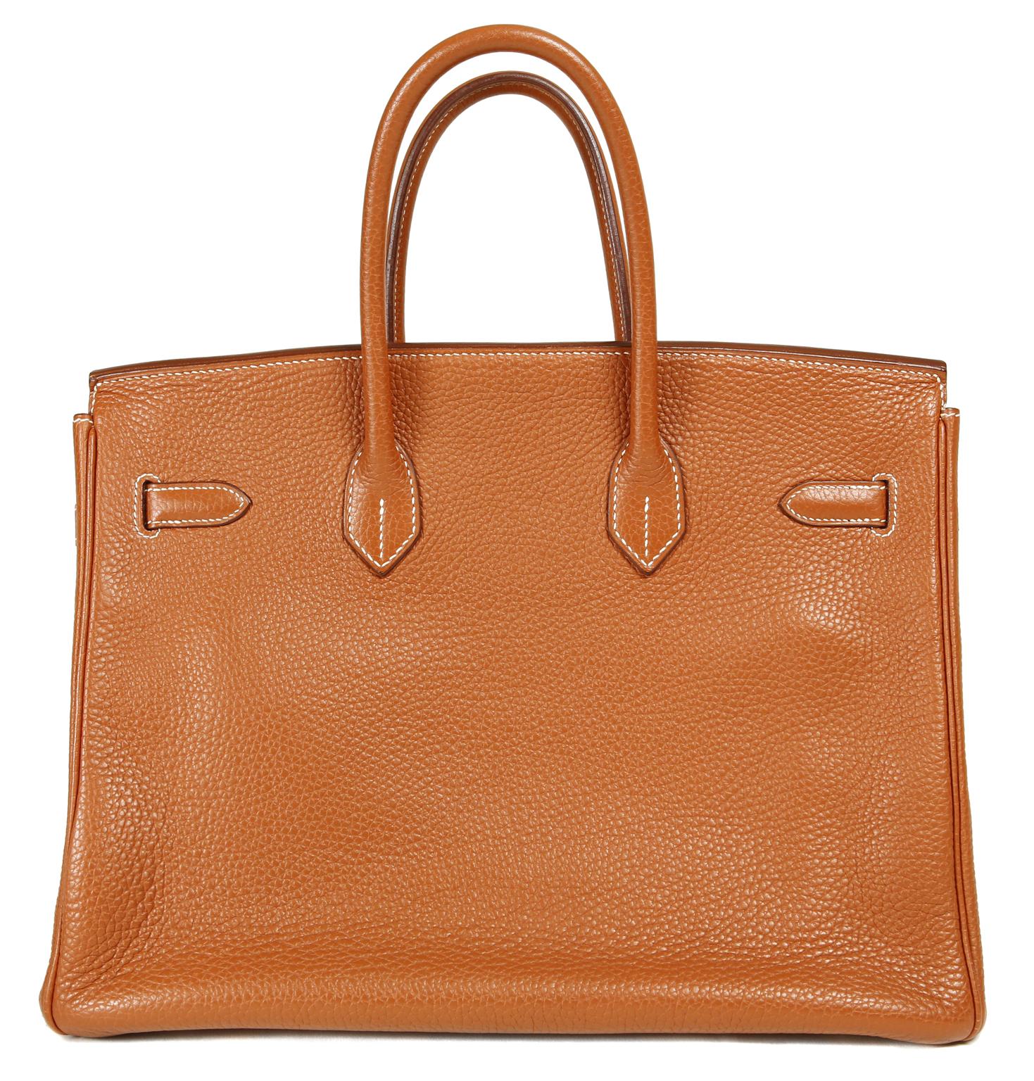 This authentic Hermès Gold Togo 35 cm Birkin is in mint condition with the protective plastic on much of the hardware.  Hermès bags are considered the ultimate luxury item the world over.  Hand stitched by skilled craftsmen, wait lists of a year or