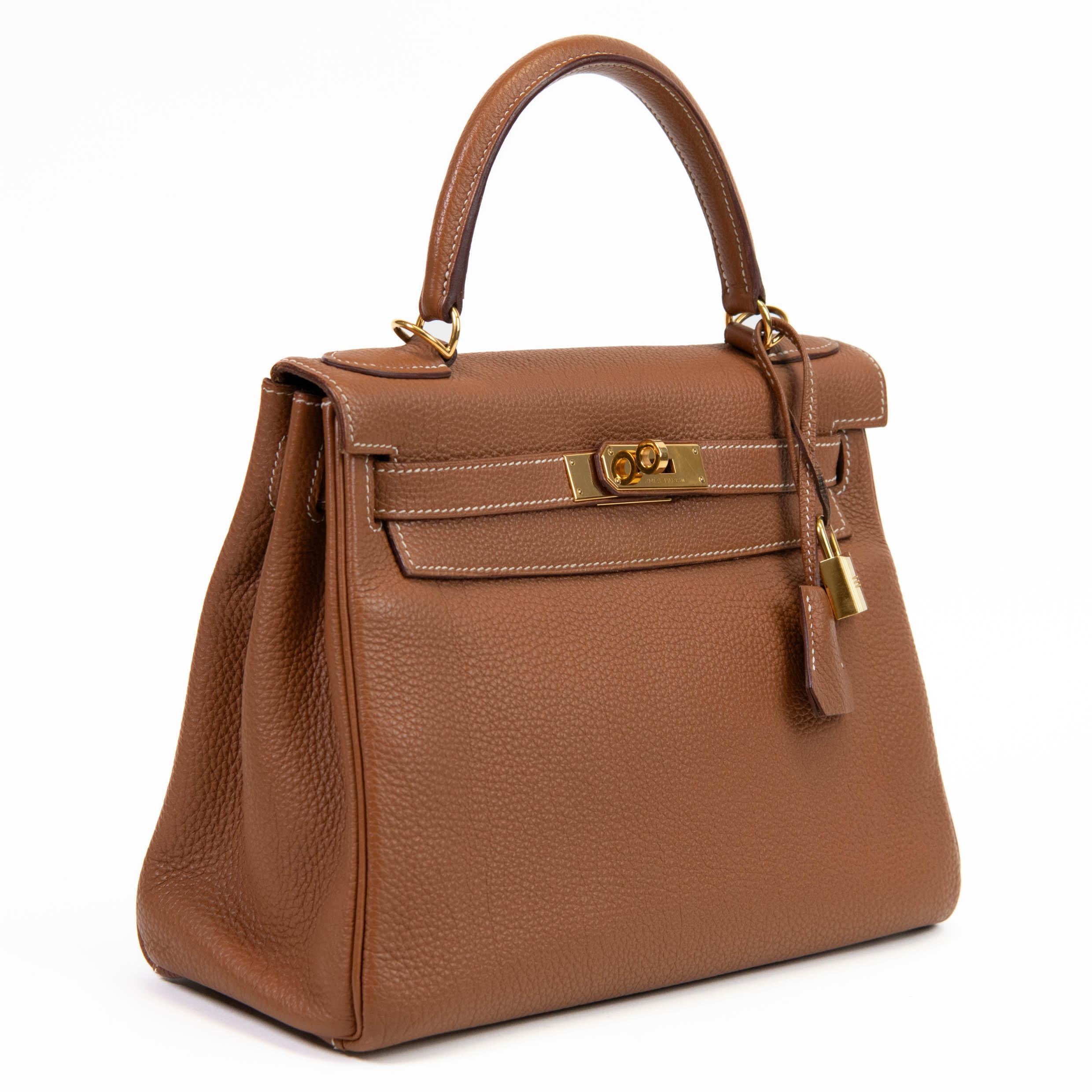 100% Authentic

This stylish Kelly handbag classic is crafted of beautifully textured calfskin leather in gold. The bag features a leather clasp top handle and a cross-over flap with strap closure and a signature Kelly Gold plated turn lock with a
