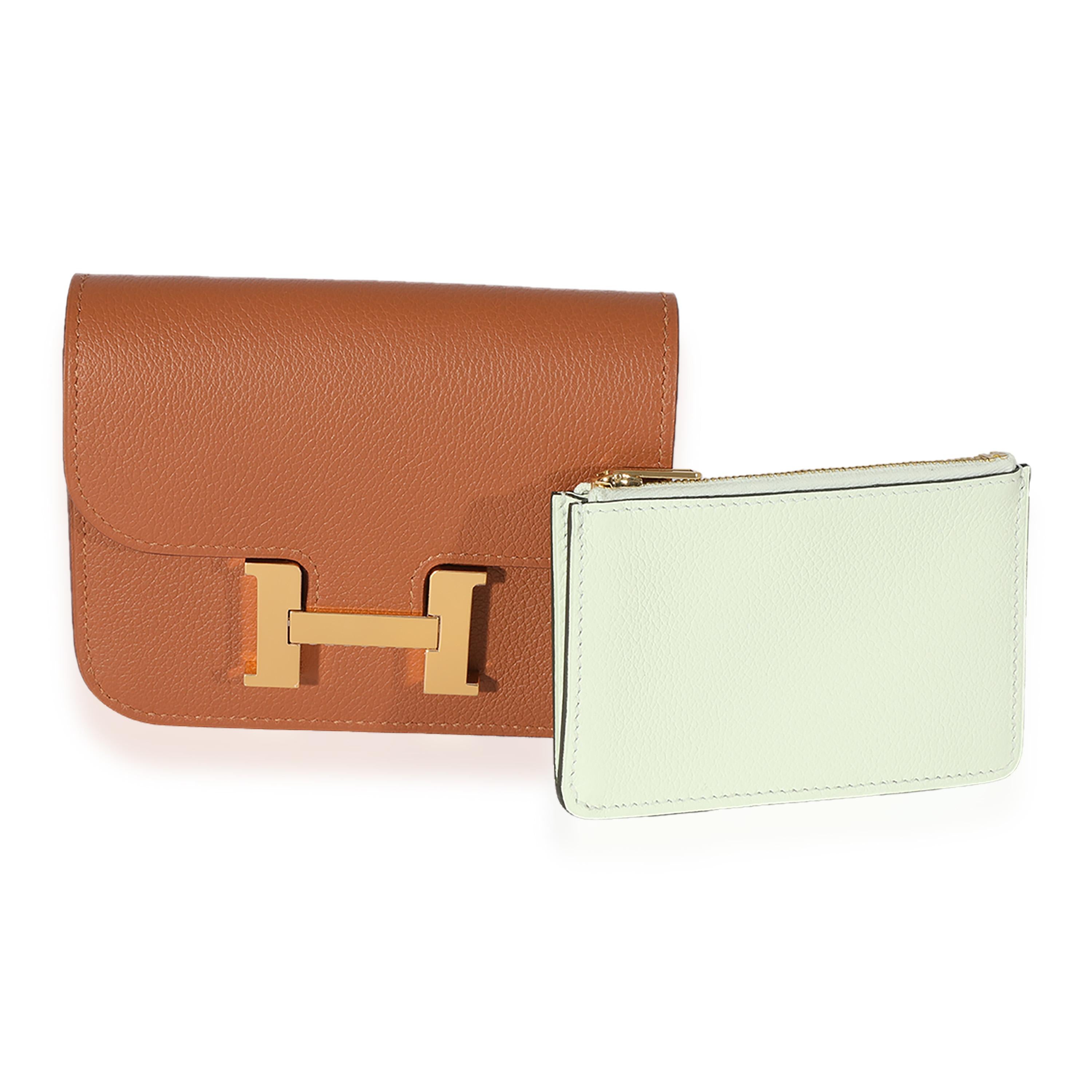 Listing Title: Hermès Gold Vert Fizz Evercolor Bicolore Constance Slim Compact GHW
SKU: 125394
MSRP: 2675.00
Condition: Pre-owned 
Handbag Condition: Mint
Condition Comments: Mint Condition. Plastic on some hardware. No visible signs of wear. Final