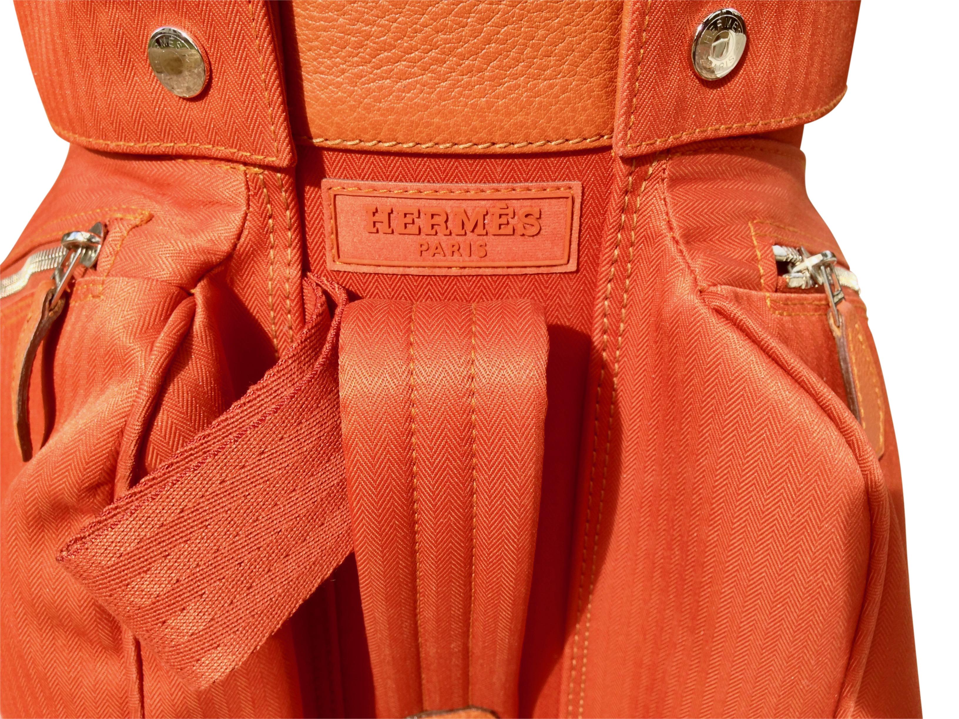 This is a rare Hermès Golf bag, limited edition in a gorgeous Tangerine orange color with Chevron fabric and buffalo leather. It comes with a shoulder strap and a giant Hermes dust bag. 
This bag was purchased in the Paris Hermès store by the