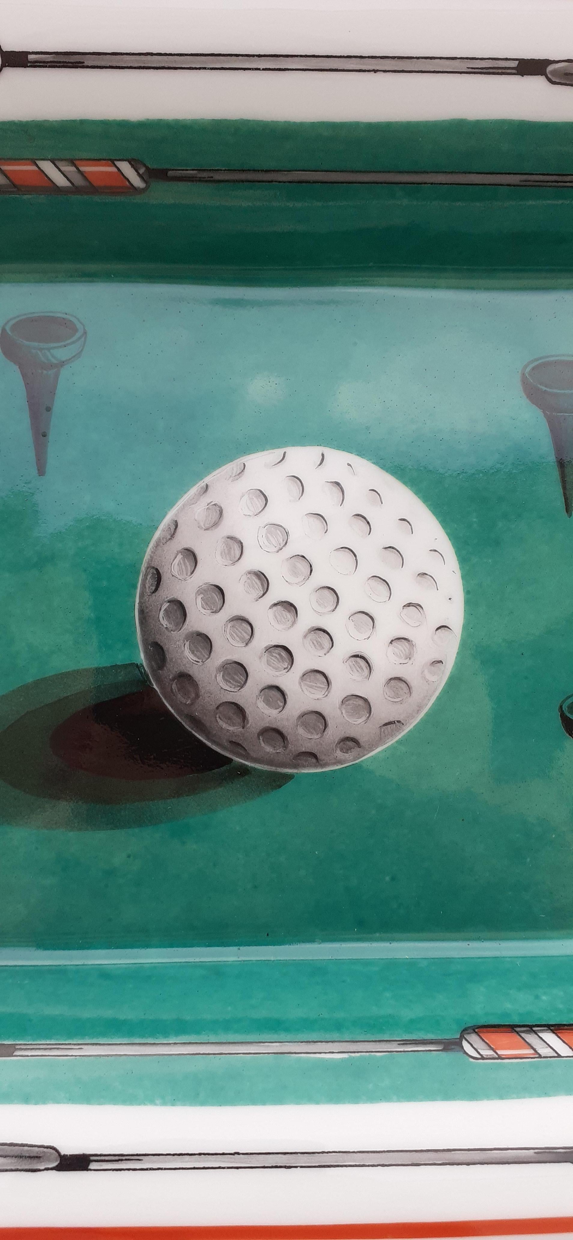 Rare and Beautiful Authentic Hermès Ashtray

Print: Golf Ball, clubs and tees

Made in France

Vintage item

Made of porcelain, edges and notches hand painted with fine gold

Bottom covered with light grey suede leather, 