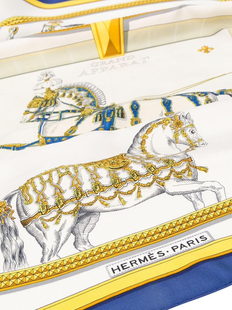 Crafted in France from the finest ivory-coloured silk, this pre-owned scarf by Hermès features a lightweight construction, a square shape and a classic equestrian themed design. For an added touch of sophistication, the piece is accented by Jaques