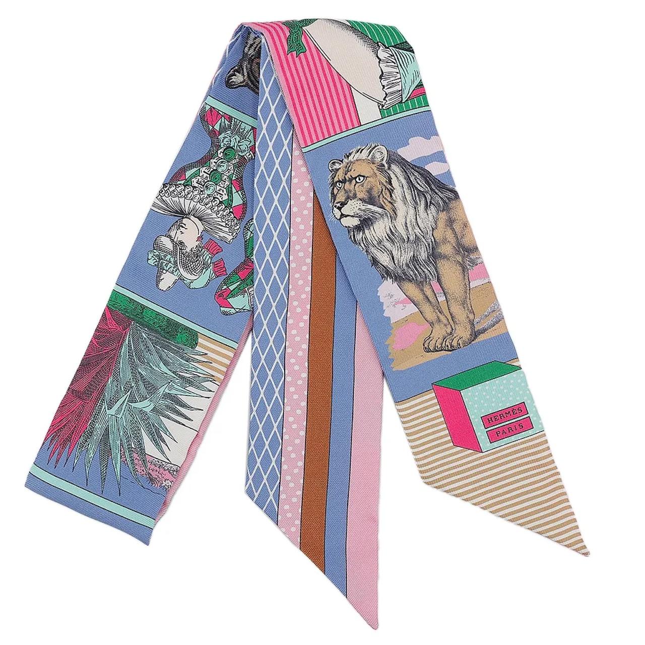 Hermes Grand Theatre Nouveau Twilly in Pink  silk (100% silk).

Excellent Condition -As new
Original Box

This small silk accessory can be tied infinite ways, bringing a whimsical touch to your everyday look!

Made in France

Designed by Gianpaolo