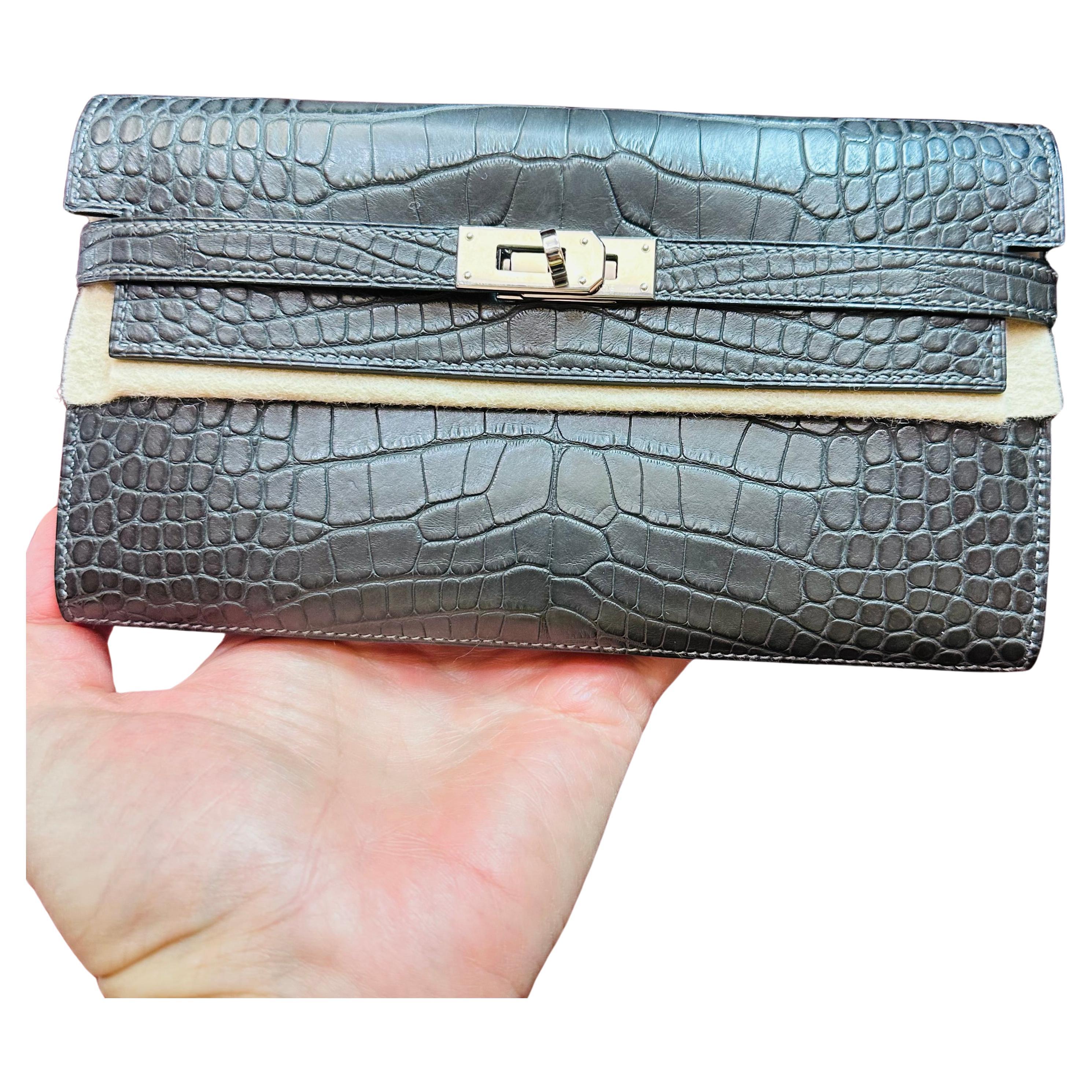 Hermes Wallet 
Graphite Alligator Kelly Wallet 
8 inch  by 4.5  Inch
Neutral Graphhite Matte Finished Alligator Skin
Excellet Condition almost New If used only few times there is Clear Protective Stickers on the Platinum Twist Hardware and