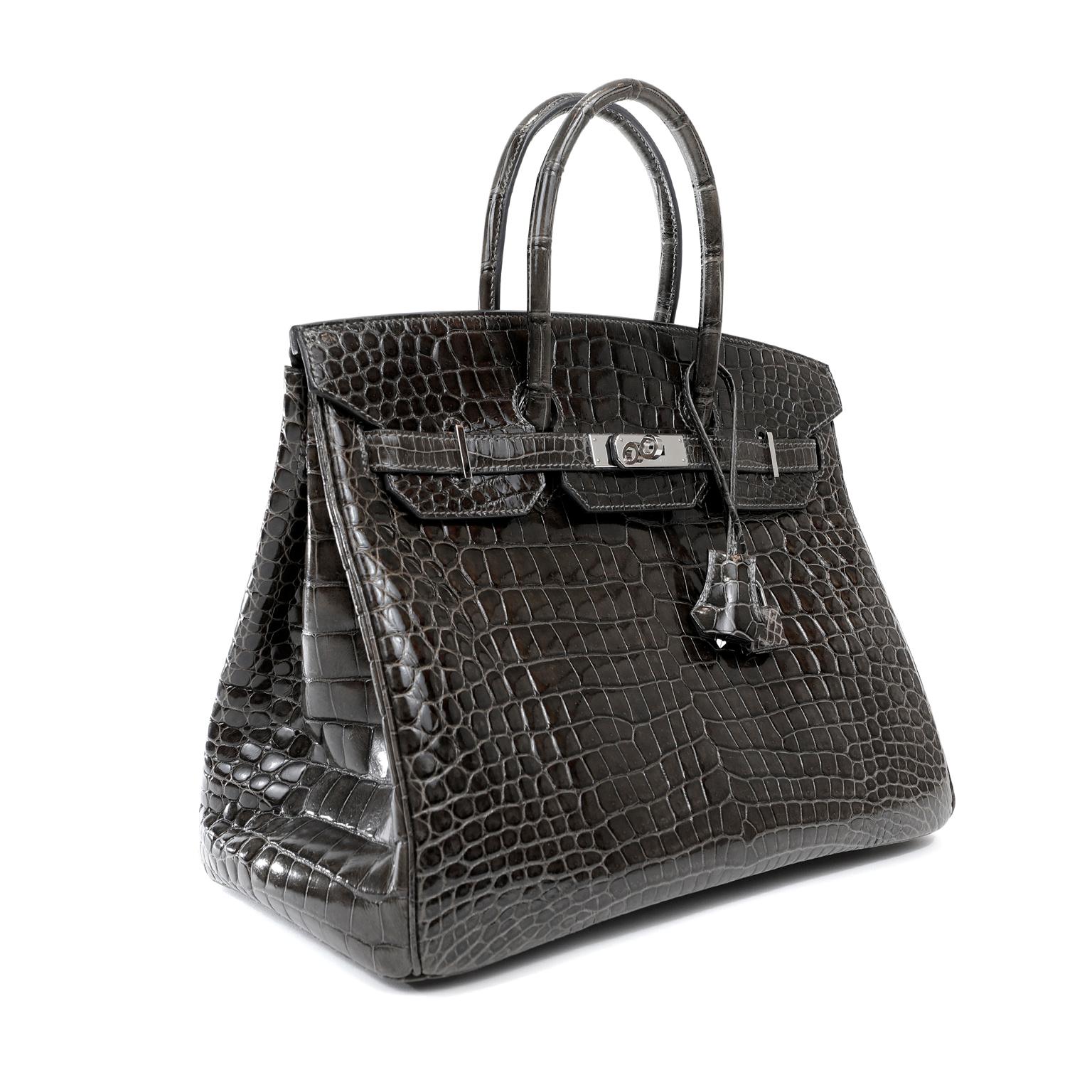 This authentic Hermès Graphite Crocodile 35 cm Birkin is in mint condition.   Hermès bags are considered the ultimate luxury item the world over.  Hand stitched by skilled craftsmen, wait lists of a year or more are commonplace for the leather