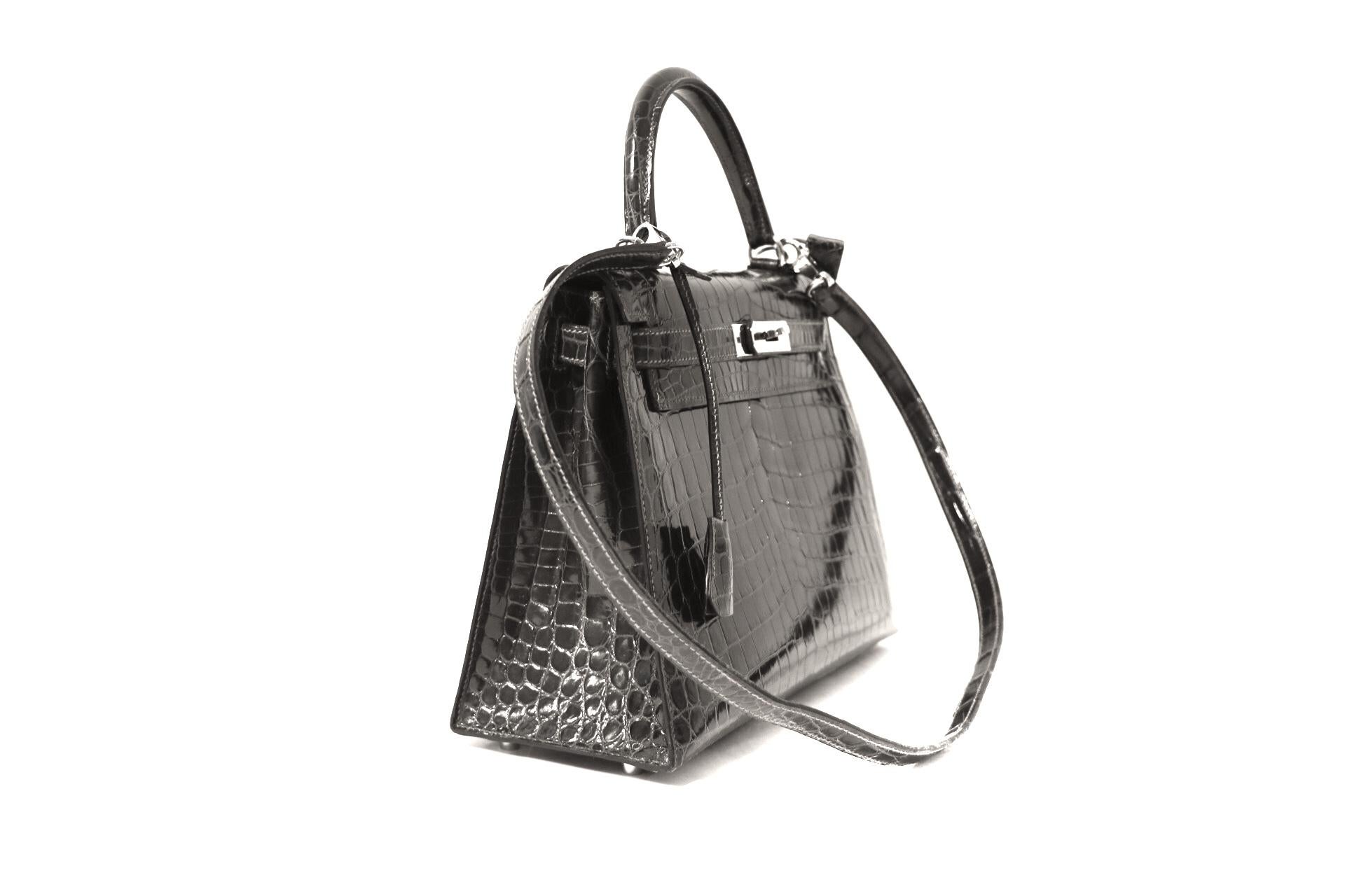 This authentic Hermès Graphite Crocodile 32 cm Kelly Bag is in pristine  condition.   Hermès bags are considered the ultimate luxury item the world over.  Hand stitched by skilled craftsmen, wait lists of a year or more are commonplace for the