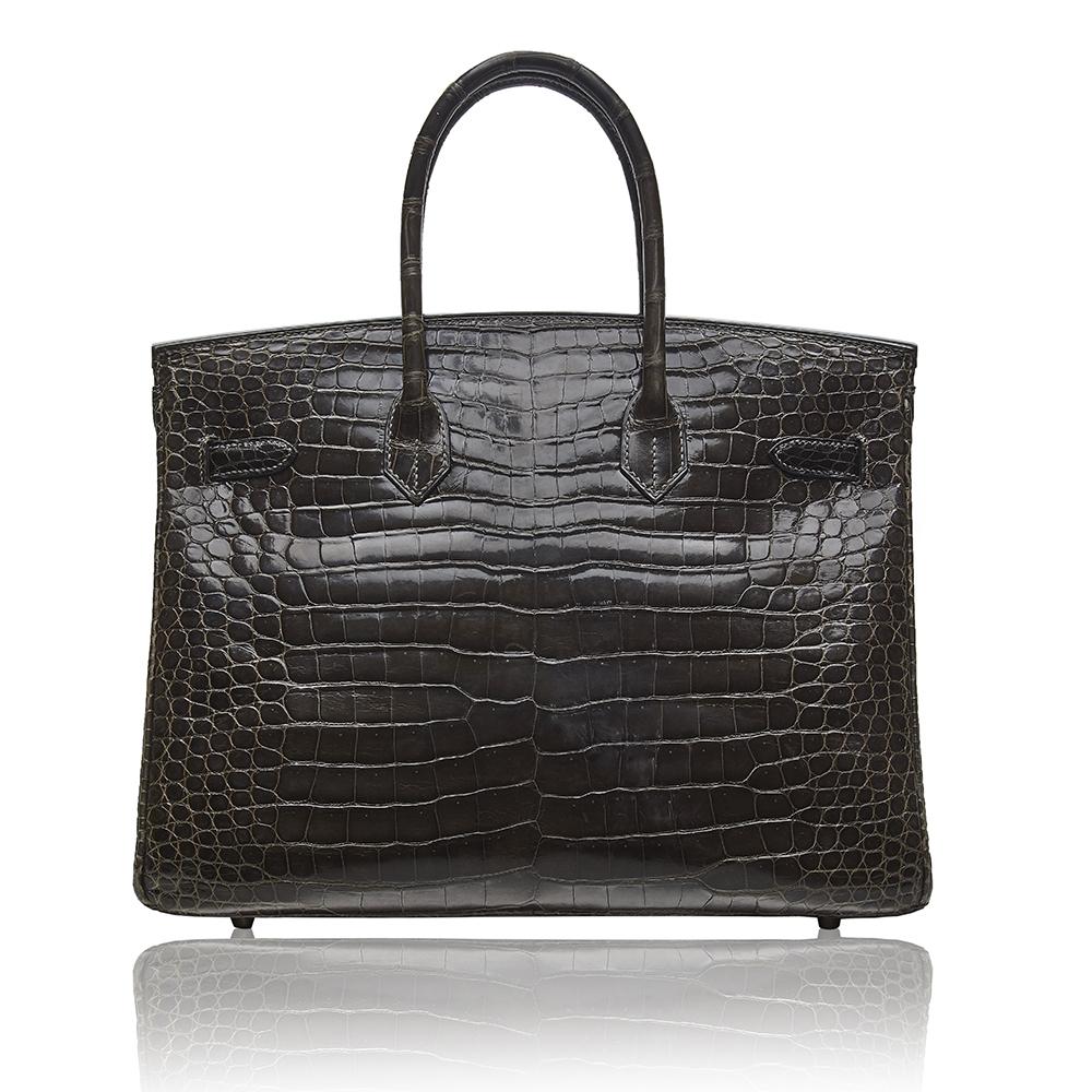 This Hermès Birkin is a truly spectacular, one-of-a-kind item and a must have for any serious collector. Crafted in a Gris Elephant Porosus Crocodile Leather and accented by silver-plated palladium hardware, this bag features two rolled leather