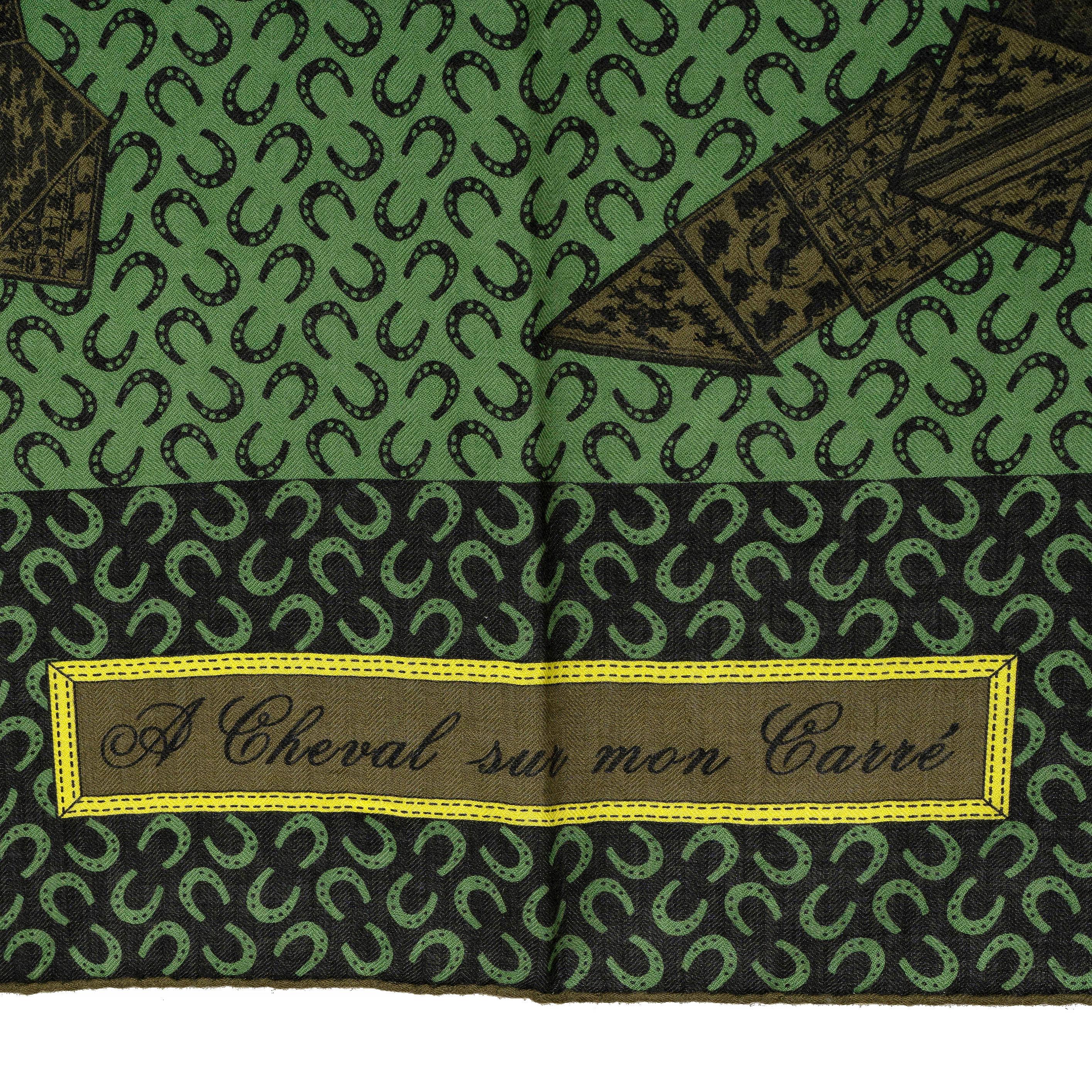 This 100% authentic Hermès A Cheval Sur Mon Carré 140 shawl, designed by Bali Barret, is crafted from a luxurious blend of green cashmere (65%) and silk (35%). It features and olive green and black print of a horse made from scarves, highlighted by
