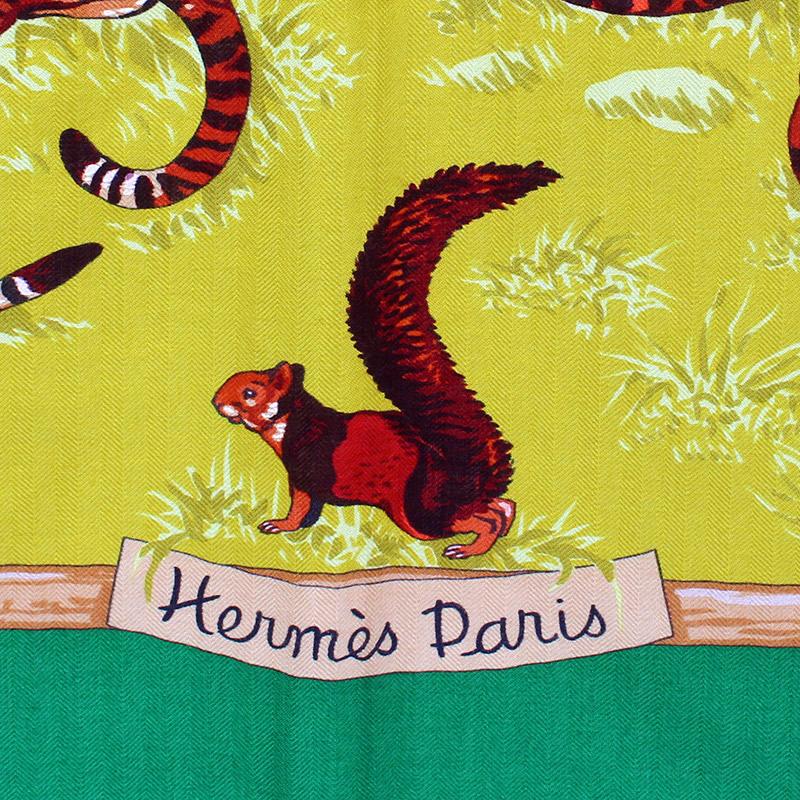 Hermes 'Tendresse Feline 140' shawl in chartreuse yellow cashmere (65%) and silk (35%) with Kelly green border and details in caramel and burnt orange. Brand new. There's a faint 'S' stamp under the care tag indicating it was sold at an Hermes