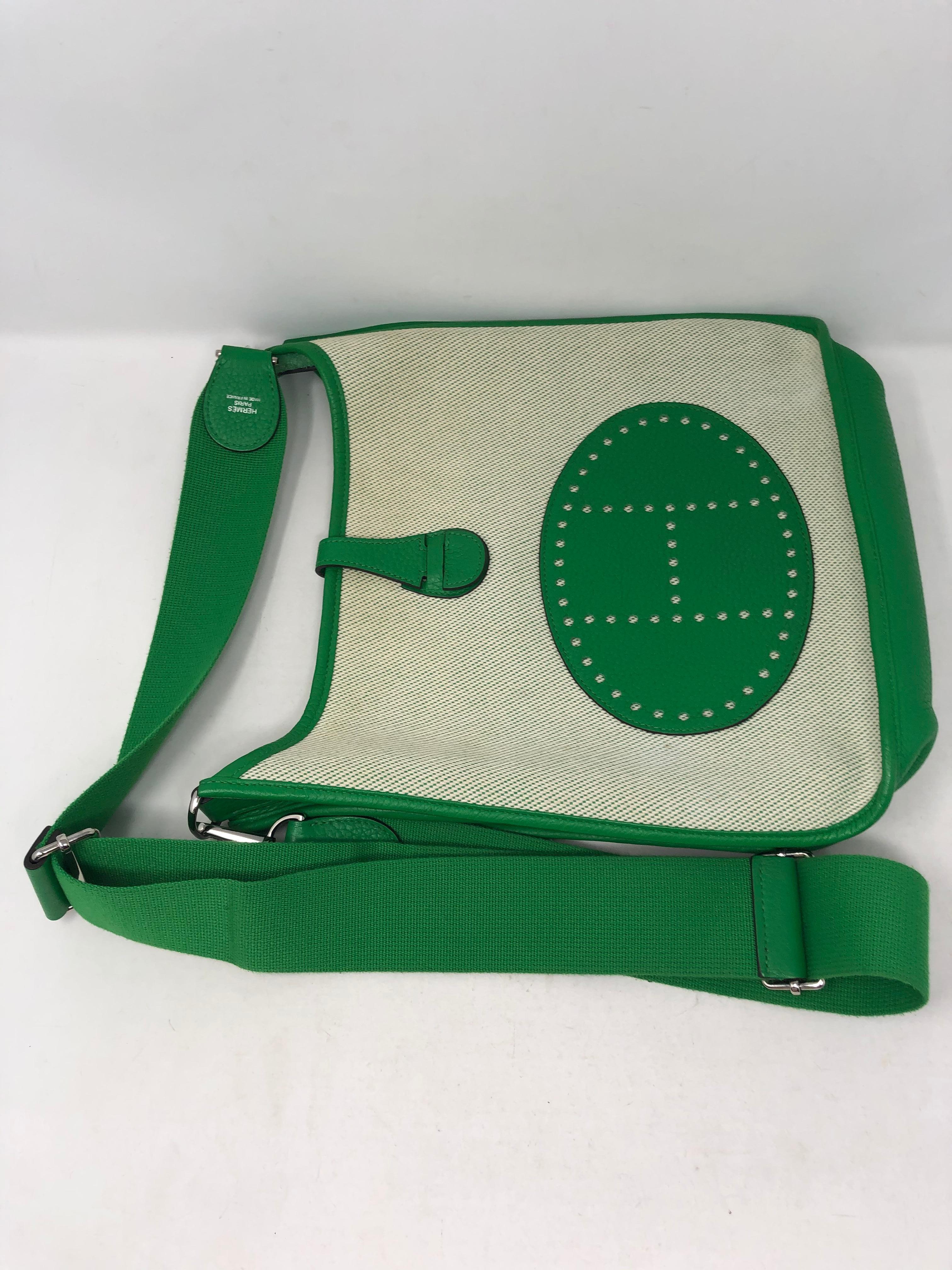 Hermes Green and Canvas Evelyne Crossbody Bag. Mint condition. Rare two-tone bag. GM size with adjustable strap. Newer series bag. Leather interior and trim in green leather. Guaranteed authentic. 