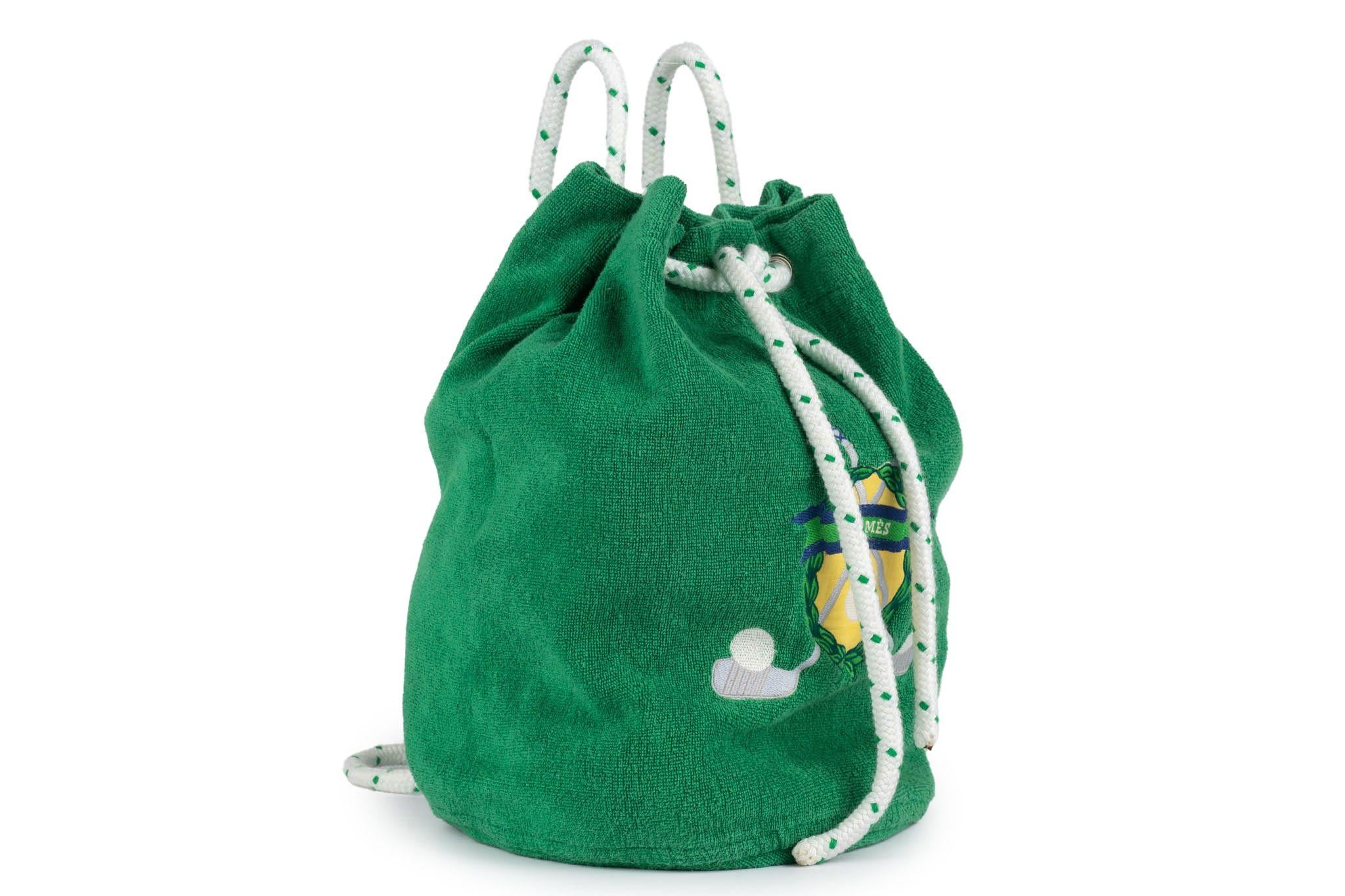 Hermès green golf terry cloth beach drawstring bag, white cord, adjustable straps. Please read label for washing instructions. Excellent condition.