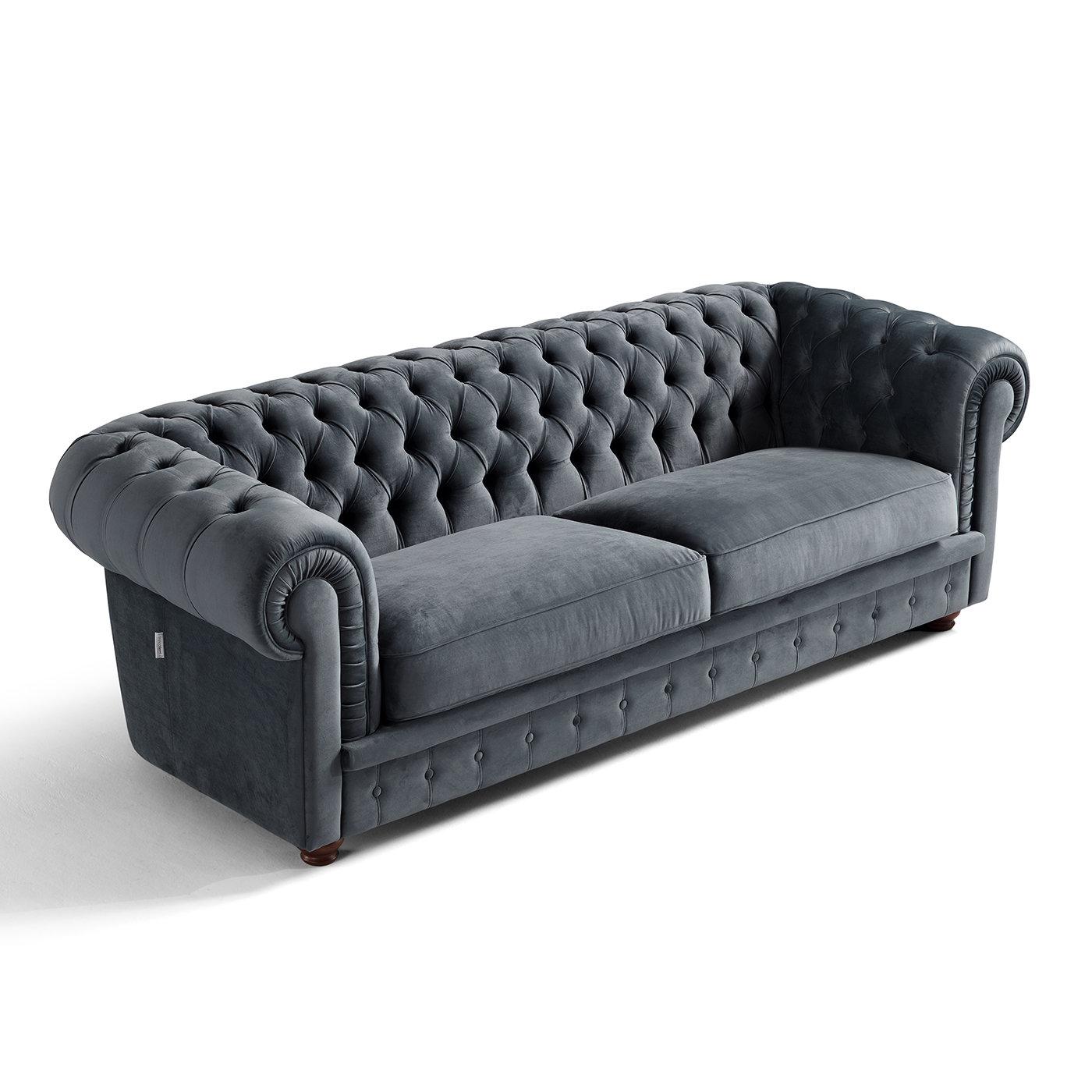 A stylish example of a Chesterfield-style sofa, this design covered in deep green fabric is distinguished by an alluring personality, showcasing a detailed aesthetic of great sophistication. A captivating button tufting graces the inner side of the