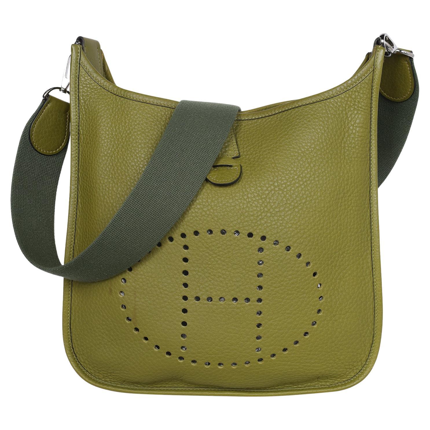 Authentic, pre-loved Hermes Green Leather Evelyne II Shoulder Bag.

Features a perforated logo display on the front, and a flat shoulder strap, the bag can be worn comfortably over the shoulder. The upper opening is secured with the help of a snap