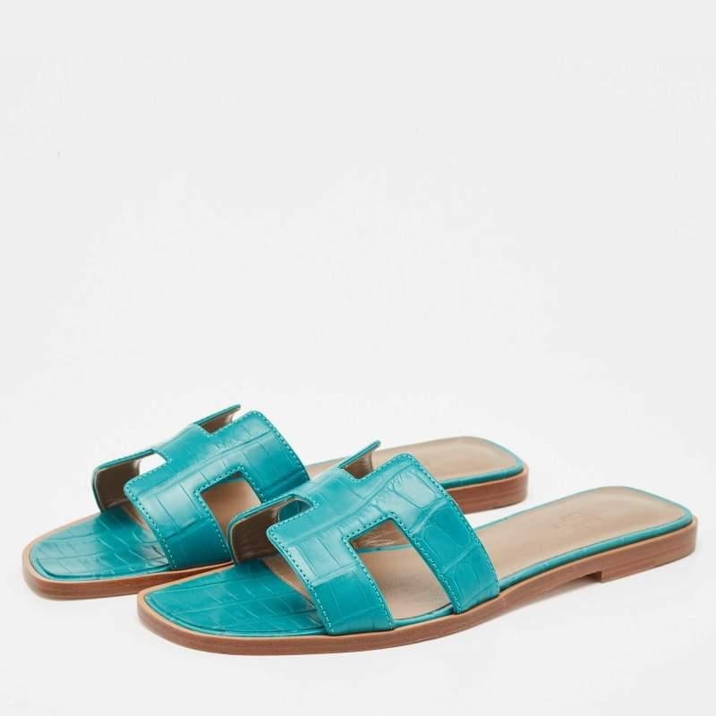 Put your best foot forward this season in these pretty Hermes sandals. These green Oran sandals have been crafted from crocodile leather in Italy and they feature the iconic H on the vamps as well as insoles meant to provide comfort at every step.