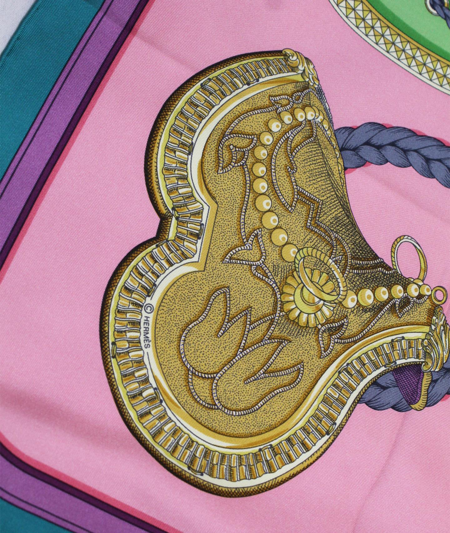 
Hermes silk scarf in green, rose and pistache colors the Grand Apparat, the Great Pageantry, was  first issued in 1962  and was created by Jacques Eudel and reissued in 2010 and 2012.  The emblematic French House of Hermes launched its now famous