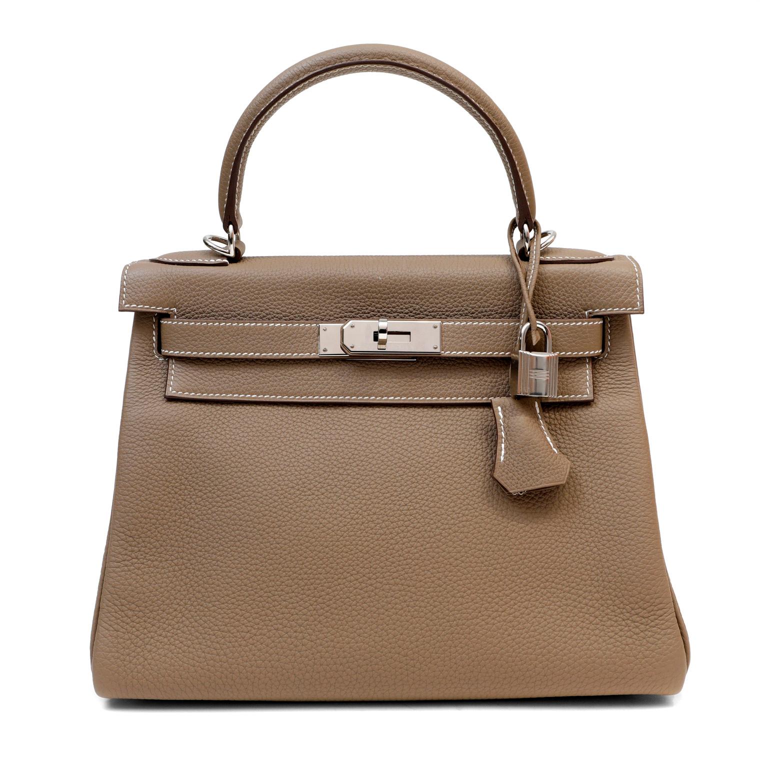 This authentic Hermès Greige Togo 28 cm Kelly is in excellent plus condition.  Hermès bags are considered the ultimate luxury item worldwide.  Each piece is handcrafted with waitlists that can exceed a year or more.  The ladylike Kelly is classic