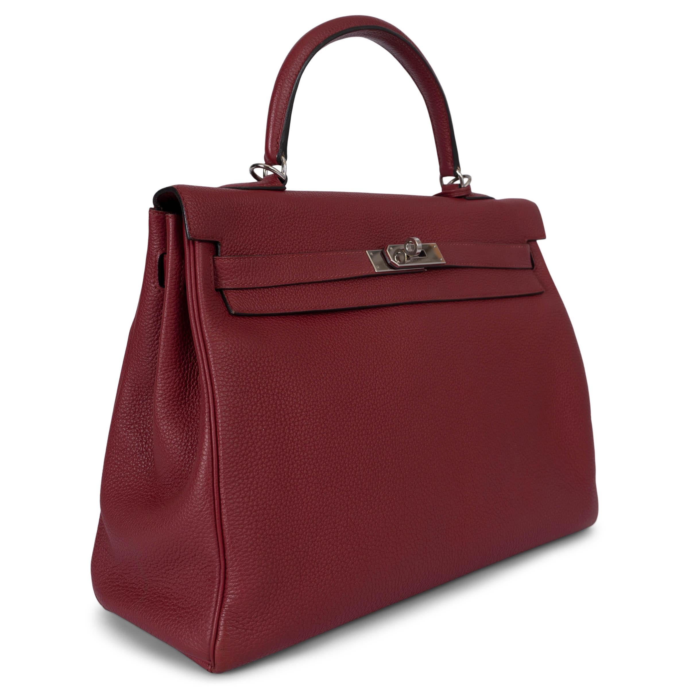 This 100% authentic Hermès Kelly 35 Retourne bag is crafted from luxurious Rouge Grenat (Pomegranate Red) Taurillon Clemence leather and features elegant palladium-tone hardware. The interior is lined in supple Chèvre (goat skin) leather, offering