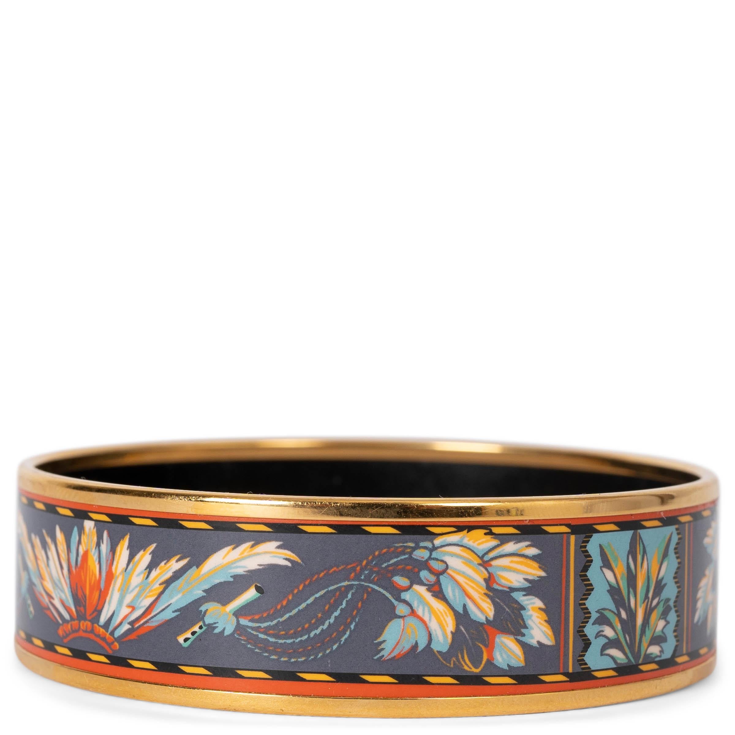 This 100% authentic Hermès Brazil wide bangle bracelet is crafted from navy blue enamel and adorned with vibrant details in blue, yellow, orange, and green. It features luxurious gold-plated hardware, adding a touch of elegance and color to any