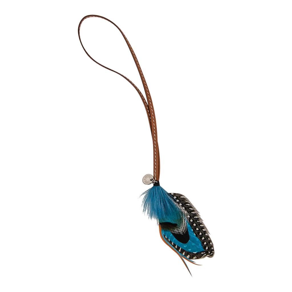 Mightychic offers an Hermes Gri Gri Mouche Fly Feather bag charm in Blue, Black and Grey.
Light hearted and playful she easily adorns a myriad bag colors in your fabulous collection.
Hermes Paris on Clou de Selle silver tag.
Comes with signature
