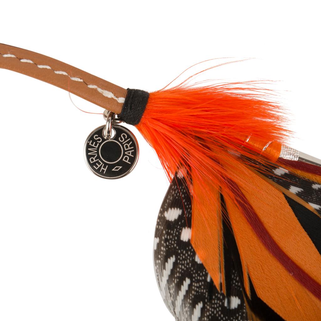 Guaranteed authentic Hermes Gri Gri Mouche Fly Feather bag charm in Orange, Brick, Black and Gray.
Light hearted and playful she easily adorns a myriad bag colors in your fabulous collection.
Hermes Paris on Clou de Selle silver tag.
Comes with