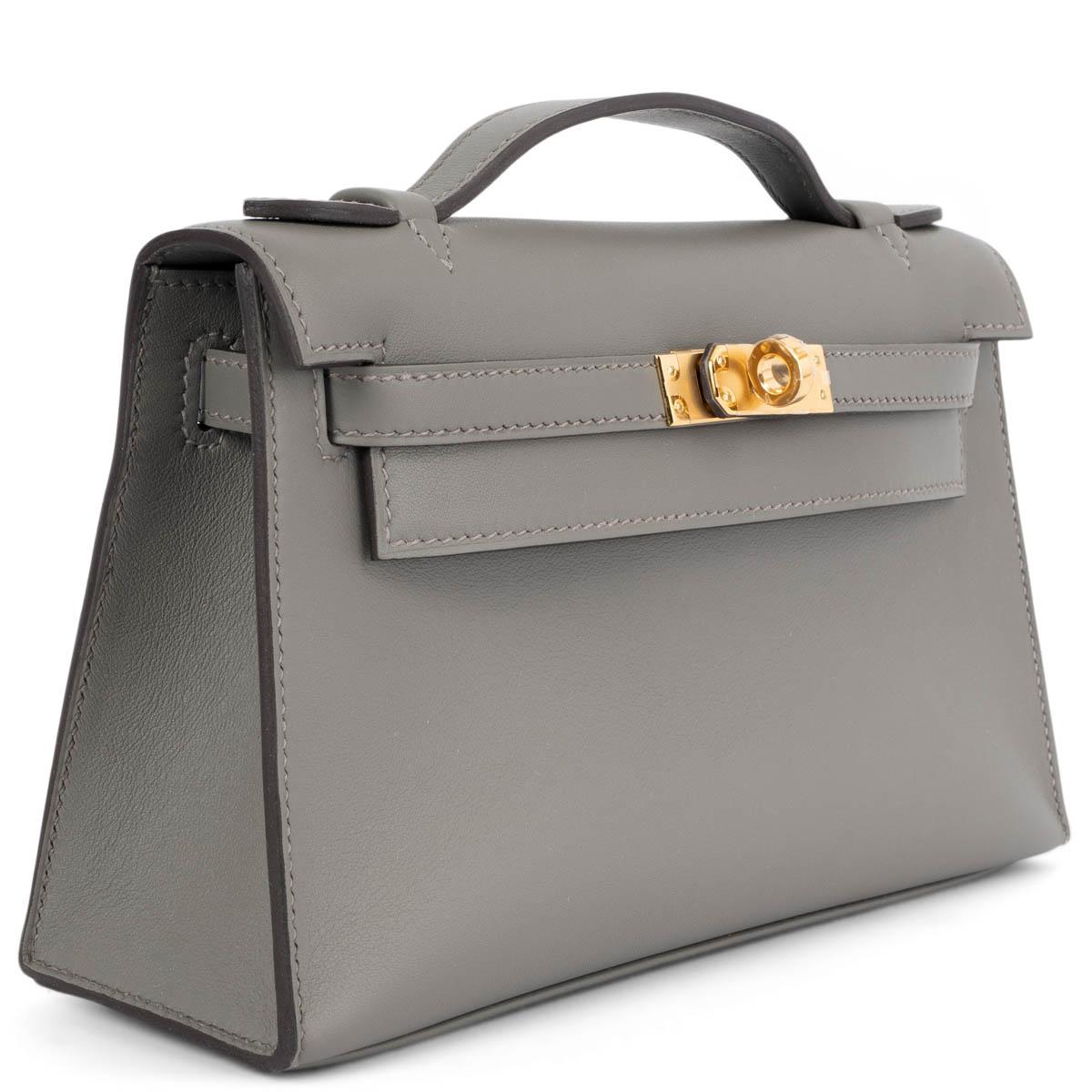 100% authentic Hermès Kelly Pochette clutch in Gris Meyer (grey) Veau Swift leather with gold-tone hardware. Lined in Chevre (goat skin) with an open pocket against the back. Brand new comes with full set. 

Measurements
Height	13cm