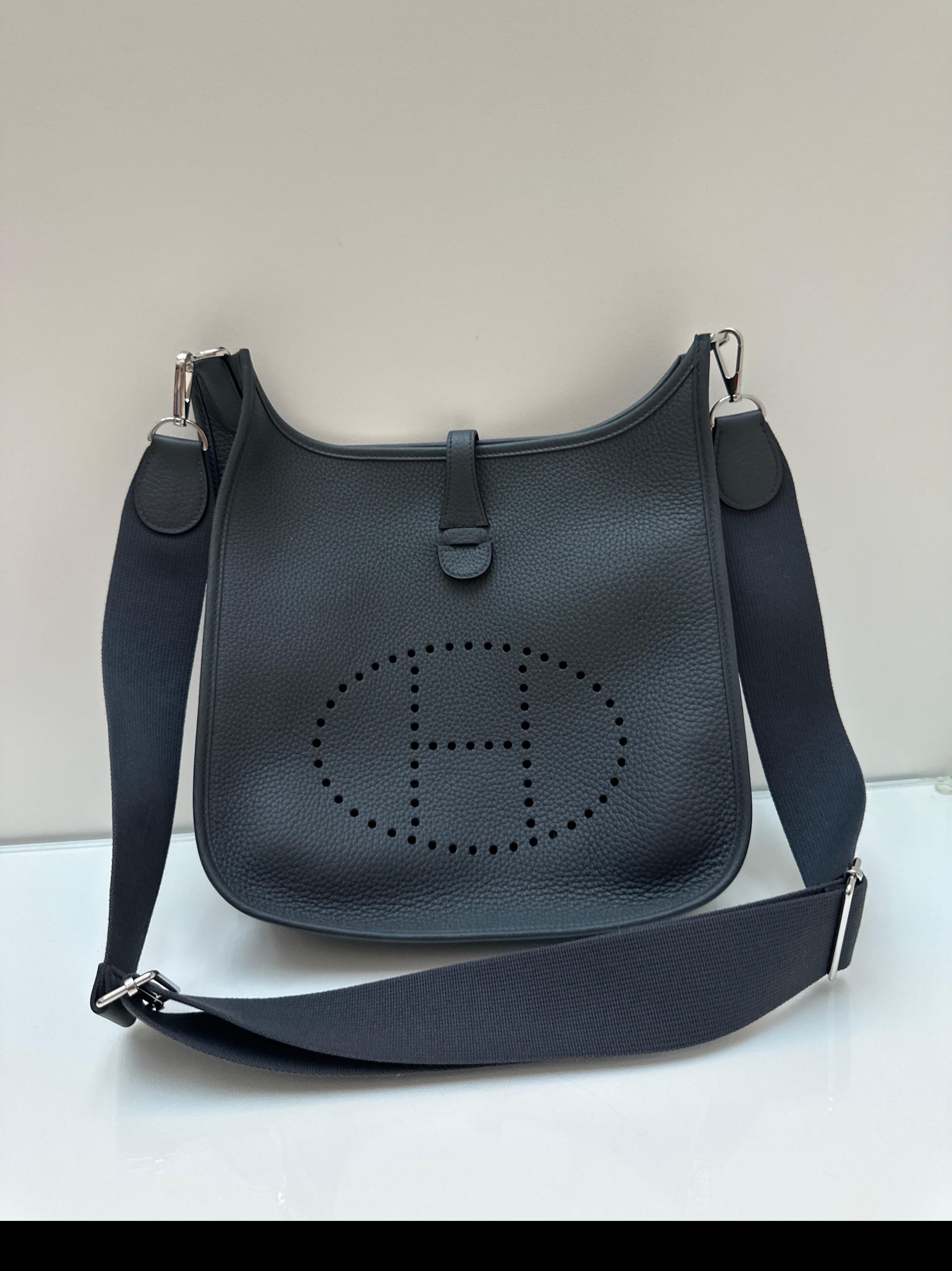 Hermes Grey Misty Evelyne Bag. New 2025 grey crossbody bag. PM size. Can also be shortened as a shoulder bag. Adjustable strap. Gorgeous grey color. Togo leather. Giftable since it is brand new. Guaranteed authentic. 