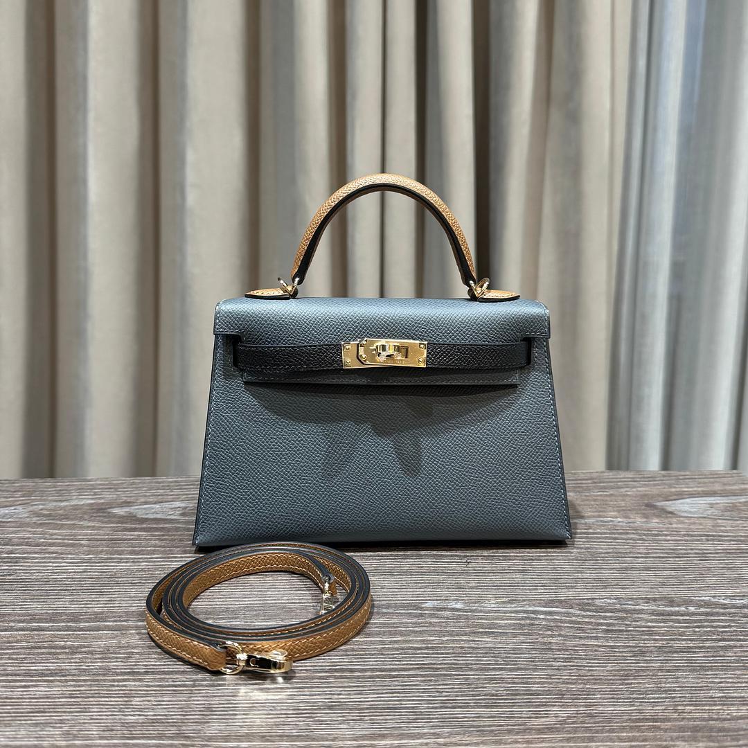 Jewell Aficionado propone la Mini Kelly 20 Sellier di Hermès in una straordinaria combinazione tricolore di pelle Gris MISTI, Noir e Alezan Epsom. Questo raffinato mix di grigio tenue, nero classico e calde tonalità neutre crea una tavolozza