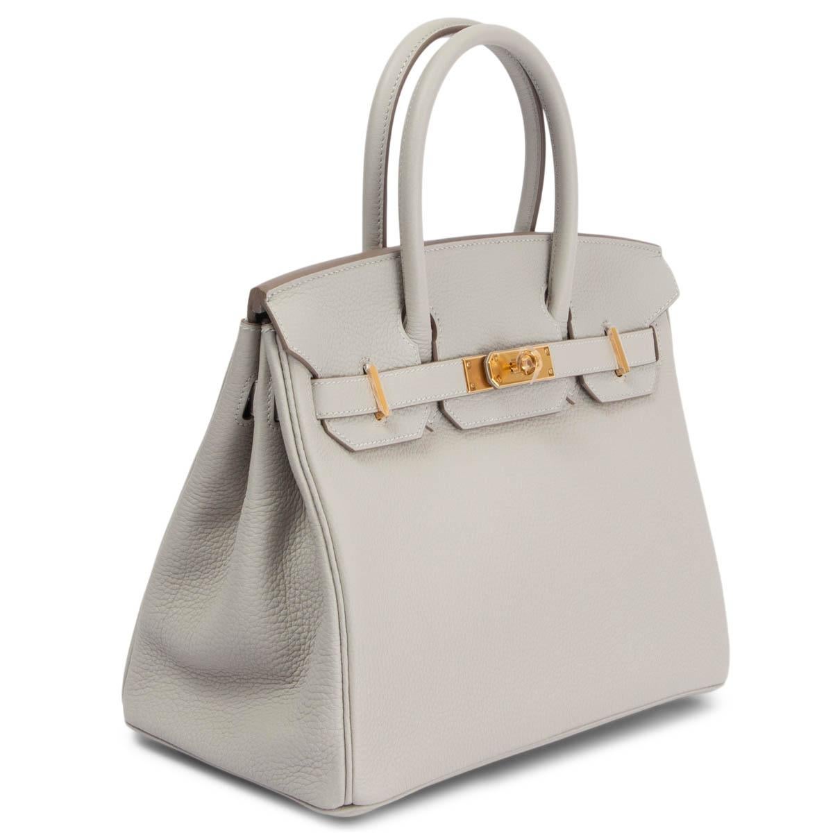 100% authentic Hermès Birkin 30 bag in Gris Perle (pale grey) Togo leather with gold-plated hardware. Lined in Chevre (goat skin) with an open pocket against the front and a zipper pocket against the back. Brand new condition. Full