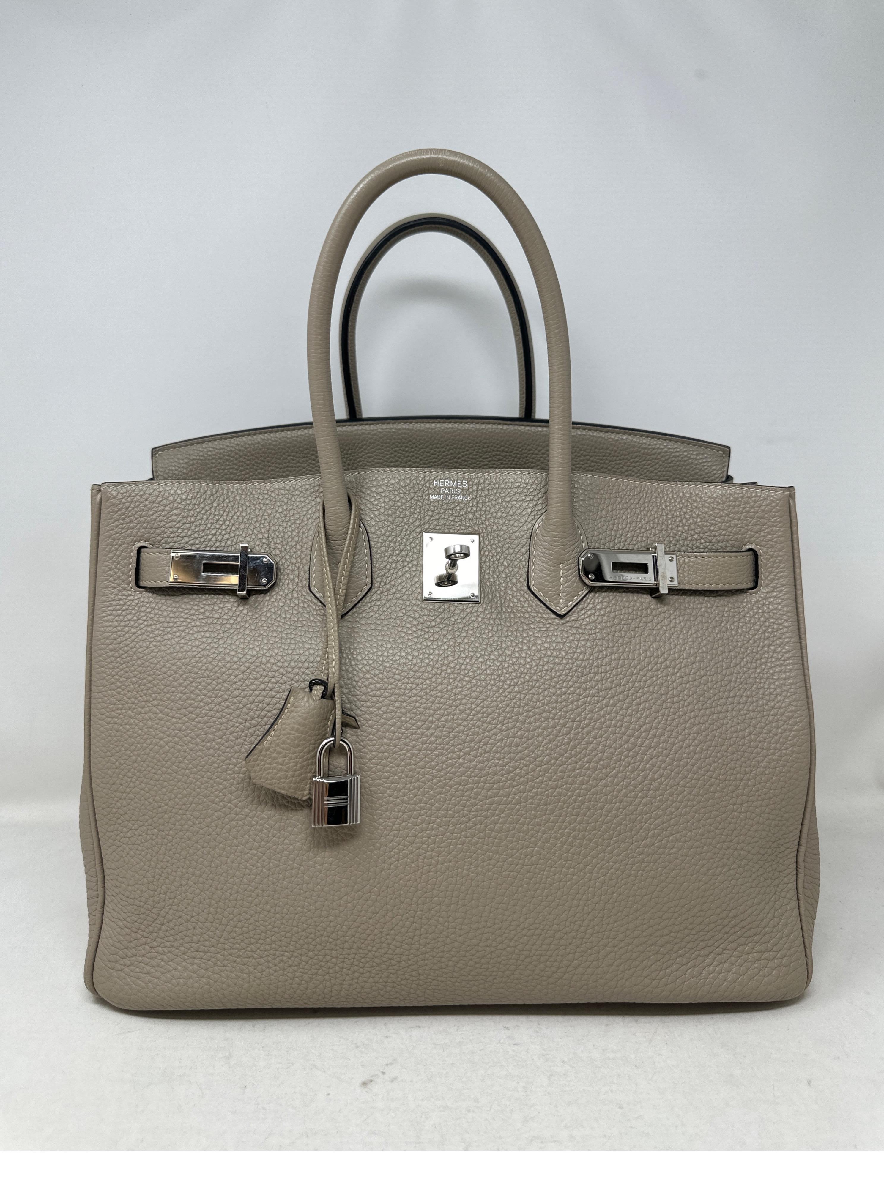 Hermes Gris Tourterelle Birkin 35 Bag. Excellent condition. Looks like new. Palladium silver hardware. Interior clean. Plastic is still on the hardware. Togo leather. Beautiful bag. Includes clochette, lock, keys, and dust bag. Guaranteed authentic. 