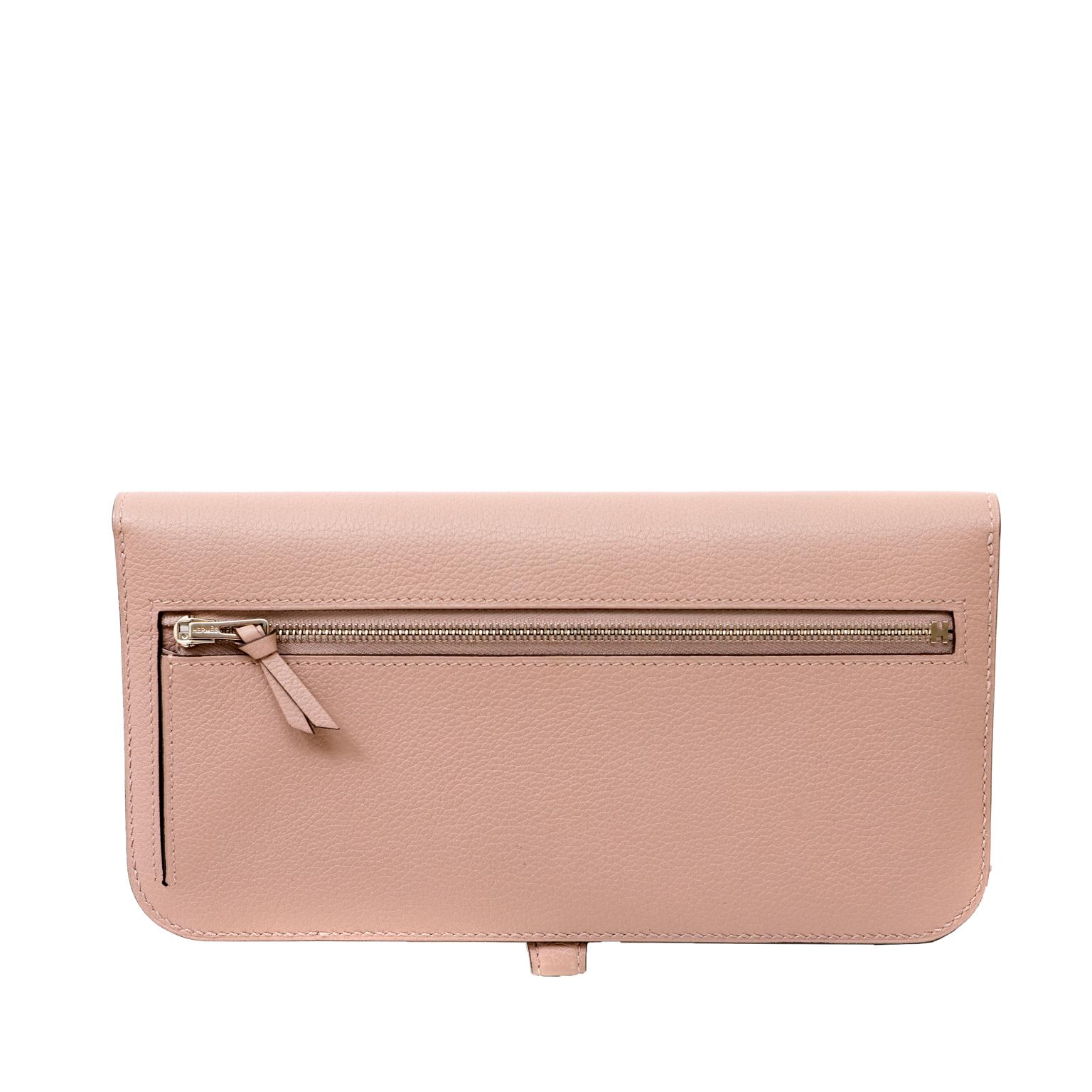 Diese authentische Hermès Gris Tourterelle Evercolor Recto- Verso Brieftasche ist in tadellosem, ungetragenem Zustand mit dem schützenden Kunststoff intakt auf die Hardware.  Sie ist so konzipiert, dass sie die wichtigsten Zahlungsmittel, Karten und